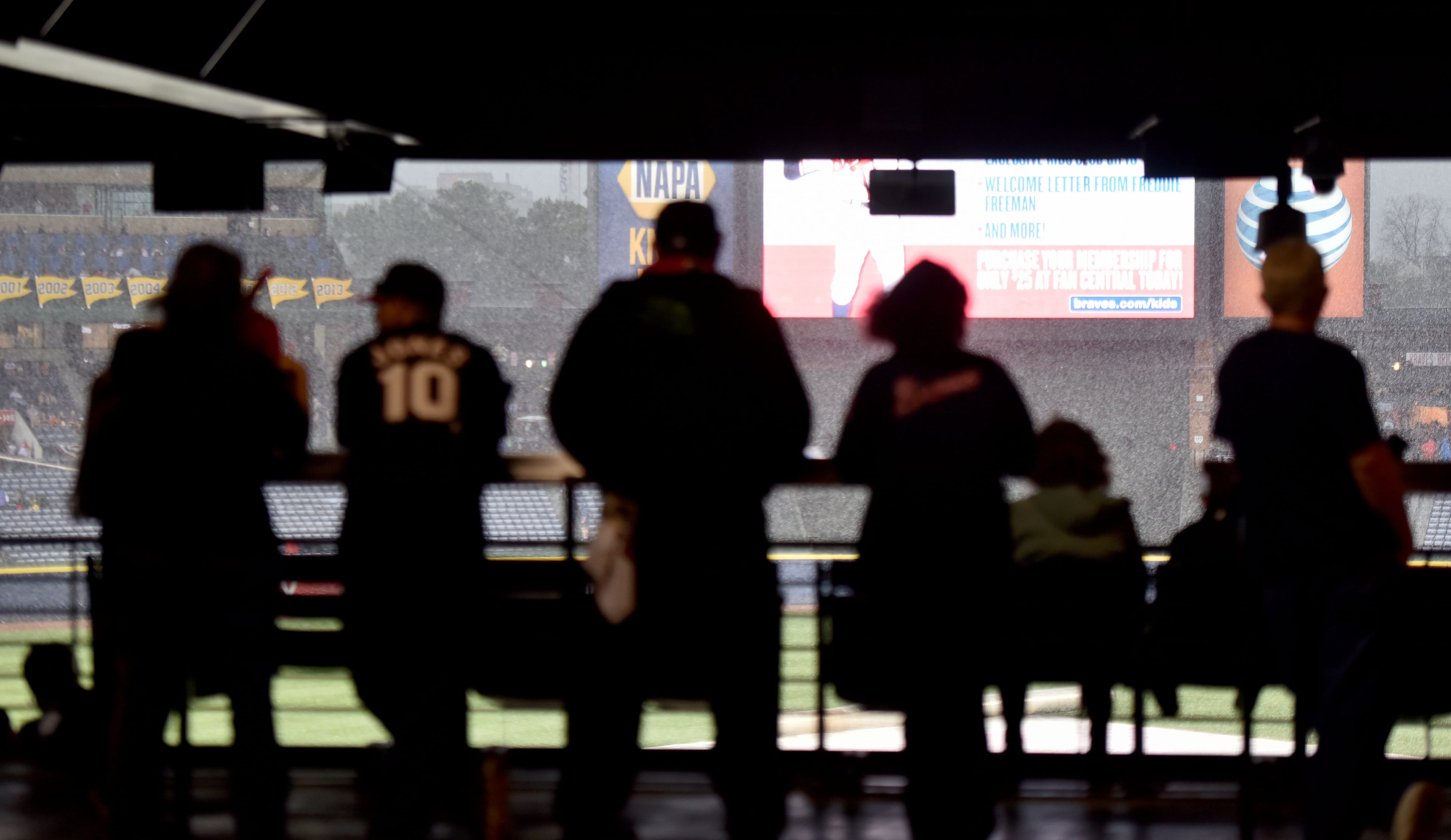 Atlanta Braves fans wait out the rain before the start of the Atlanta Braves season opener against the New York Mets at Turner Field in Atlanta on Friday, April 10, 2015. HYOSUB SHIN / HSHIN@AJC.COM