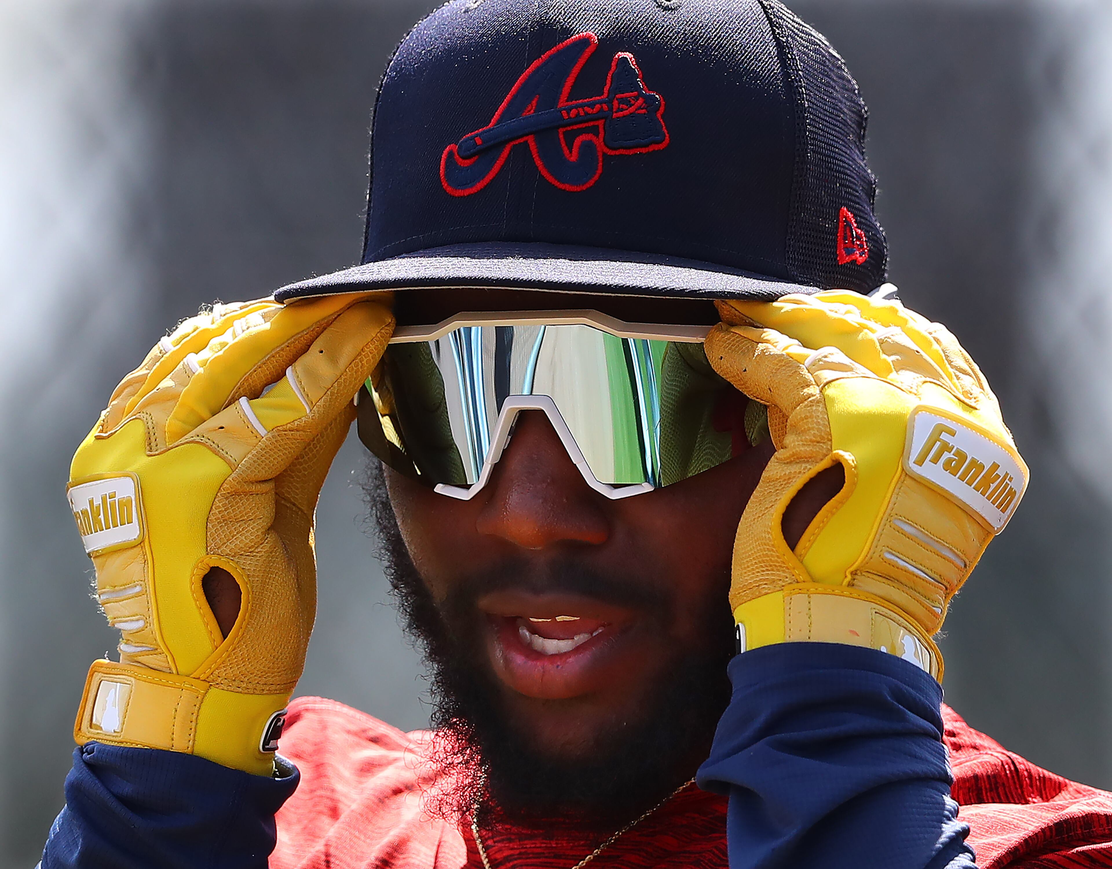 030622 North Port: Atlanta Braves outfielder Michael Harris II puts on his sunglasses as he takes the field for batting practice on the first day of Braves minor league spring training camp on Sunday, March 6, 2022, in North Port. “Curtis Compton / Curtis.Compton@ajc.com”`