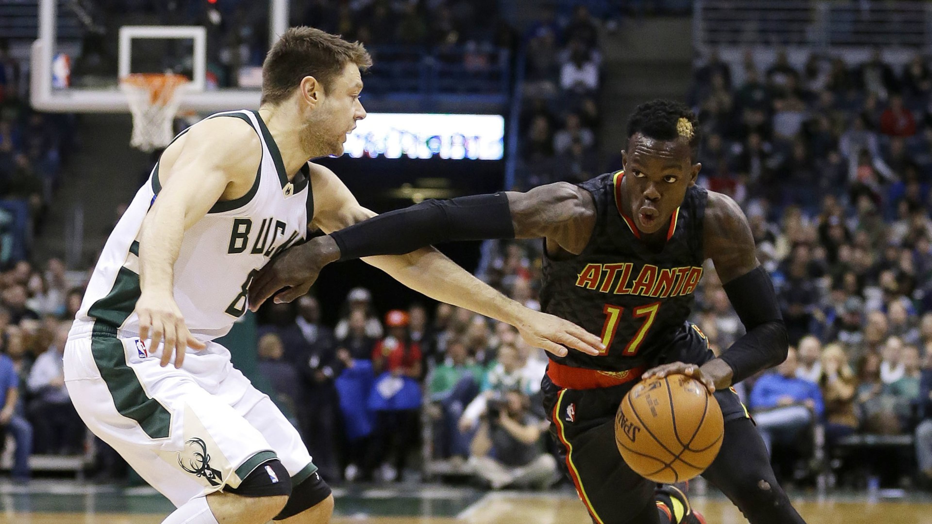 Atlanta Hawks’ Dennis Schroder (17) drives to the basket against Milwaukee Bucks’ Matthew Dellavedova during the second half of an NBA basketball game Friday, Dec. 9, 2016, in Milwaukee. The Hawks won 114-110. (AP Photo/Aaron Gash)