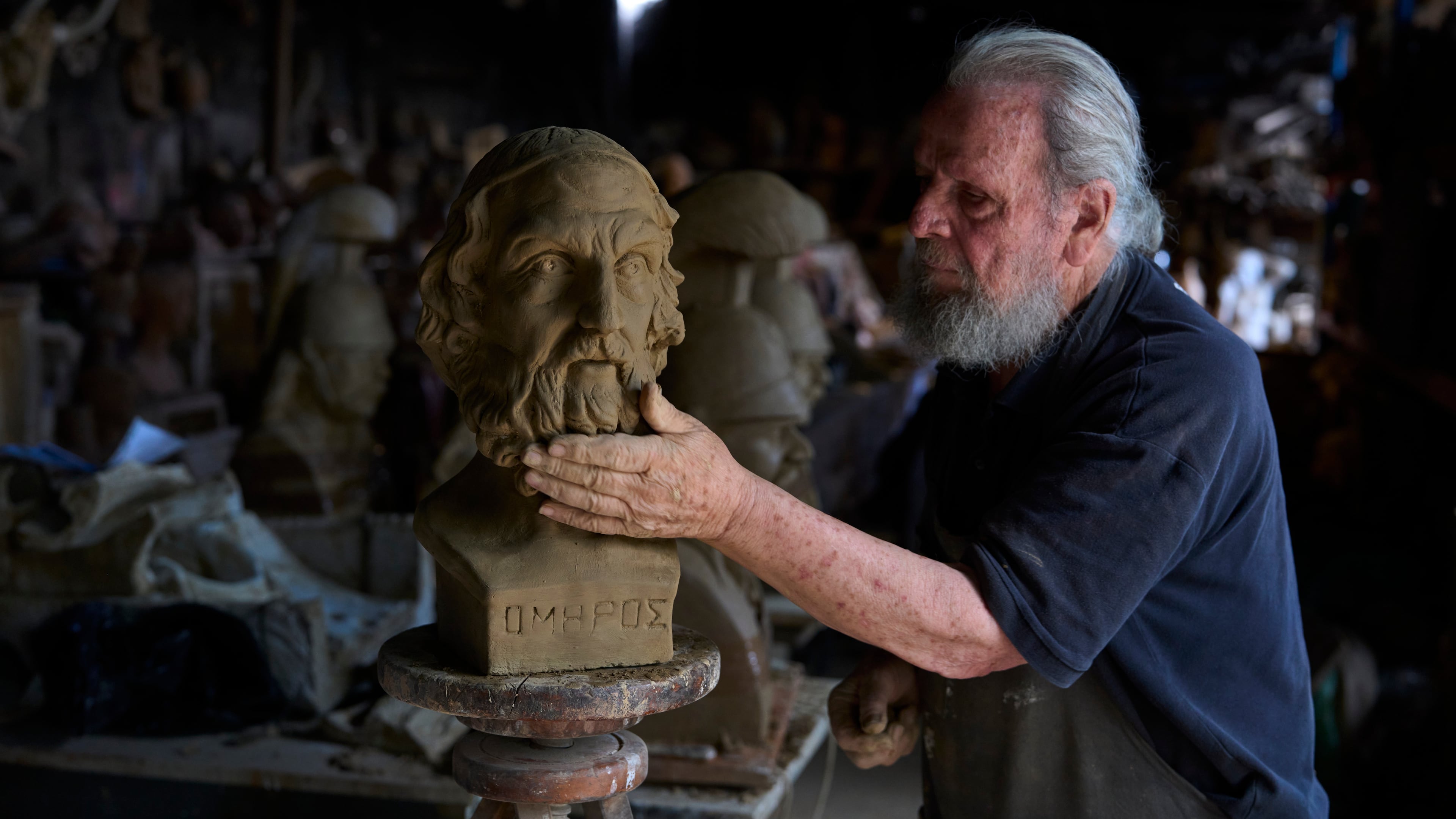 Sculptor and ceramicist Haralambos Goumas works on a terracotta bust of the ancient Greek poet Homer, the author of the Iliad and the Odyssey, at his workshop in the Athens suburb of Aigaleo, Wednesday, May 27, 2026. (AP Photo/Petros Giannakouris)