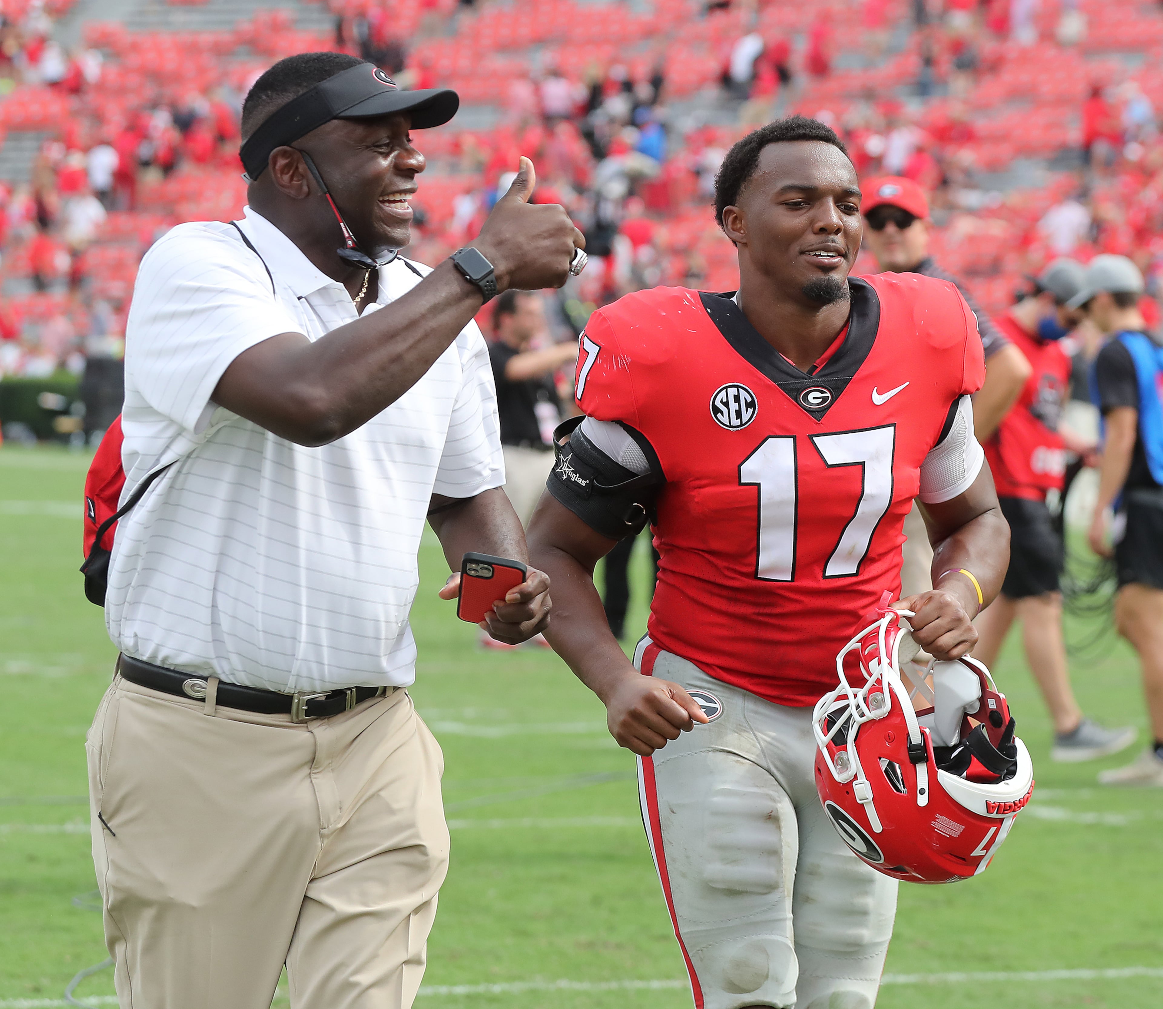 100221 ATHENS: Georgia Director of Player Support Bryant Gantt and inside linebacker Nakobe Dean celebrate a 37-0 shut out over Arkansas in a NCAA college football game on Saturday, Oct. 2, 2021, in Athens. “Curtis Compton / Curtis.Compton@ajc.com”