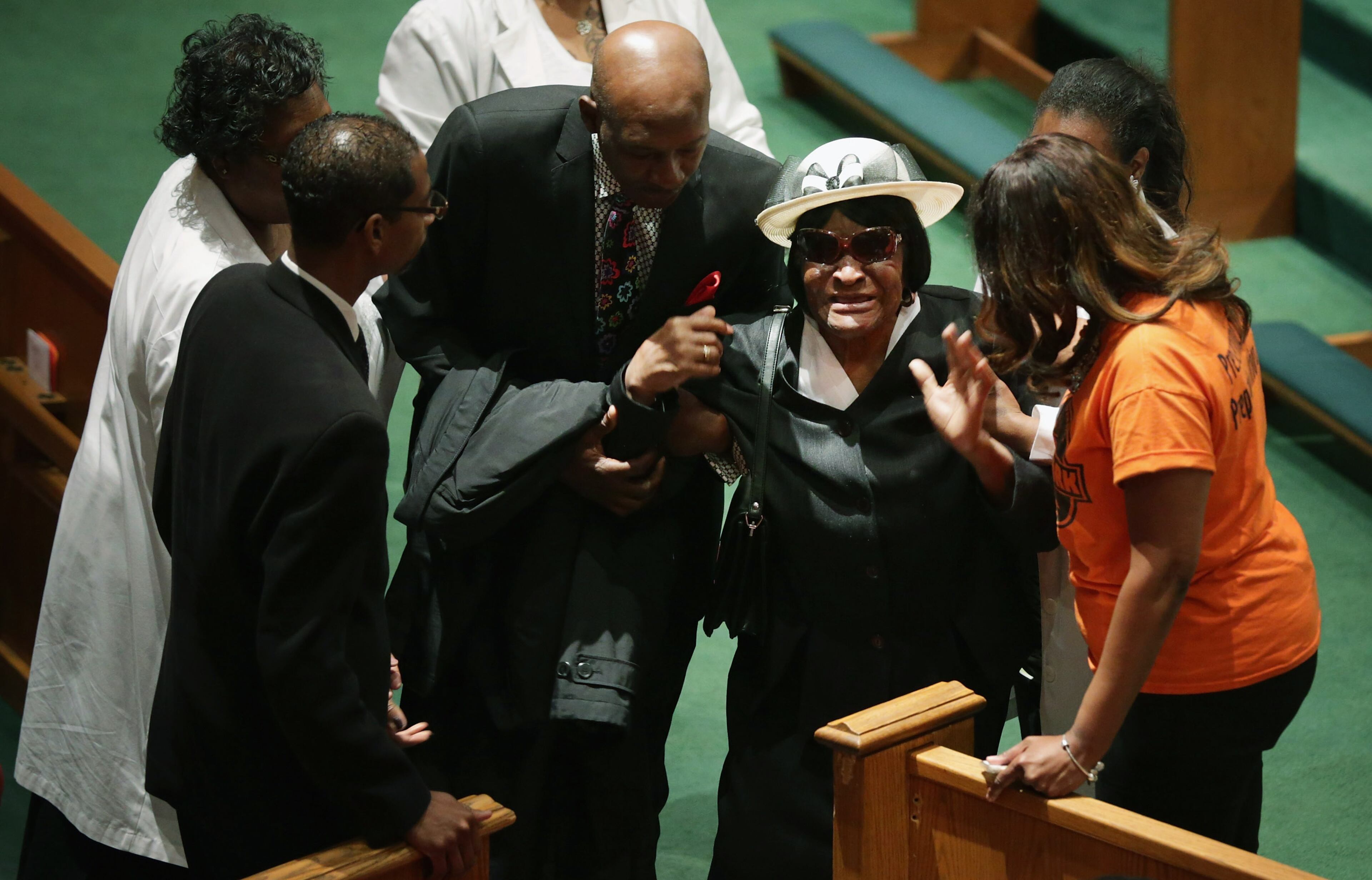BALTIMORE, MD - APRIL 27: A mourning family member of Freddie Gray is helped to her seat during his funeral at the New Shiloh Baptist Church during his funeral April 27, 2015 in Baltimore, Maryland. Gray, 25, was arrested for possessing a switch blade knife April 12 outside the Gilmor Homes housing project on Baltimore's west side. According to his attorney, Gray died a week later in the hospital from a severe spinal cord injury he received while in police custody. (Photo by Chip Somodevilla/Getty Images)
