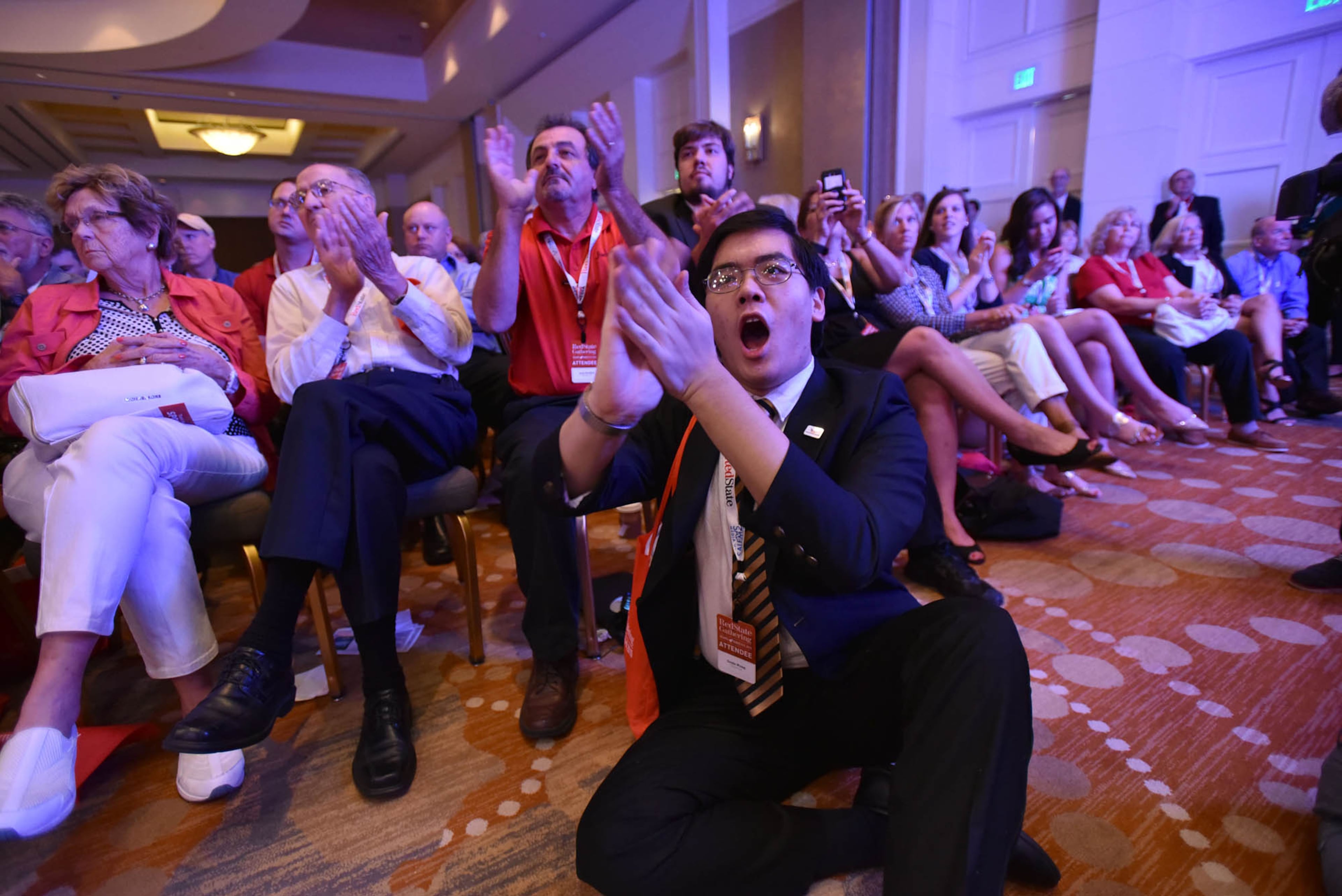 Doyle Wang, of Lilburn, reacts to Wisconsin Gov. Scott Walker's speech during the RedState Gathering at Intercontinental Buckhead Hotel on Saturday, August 8, 2015.