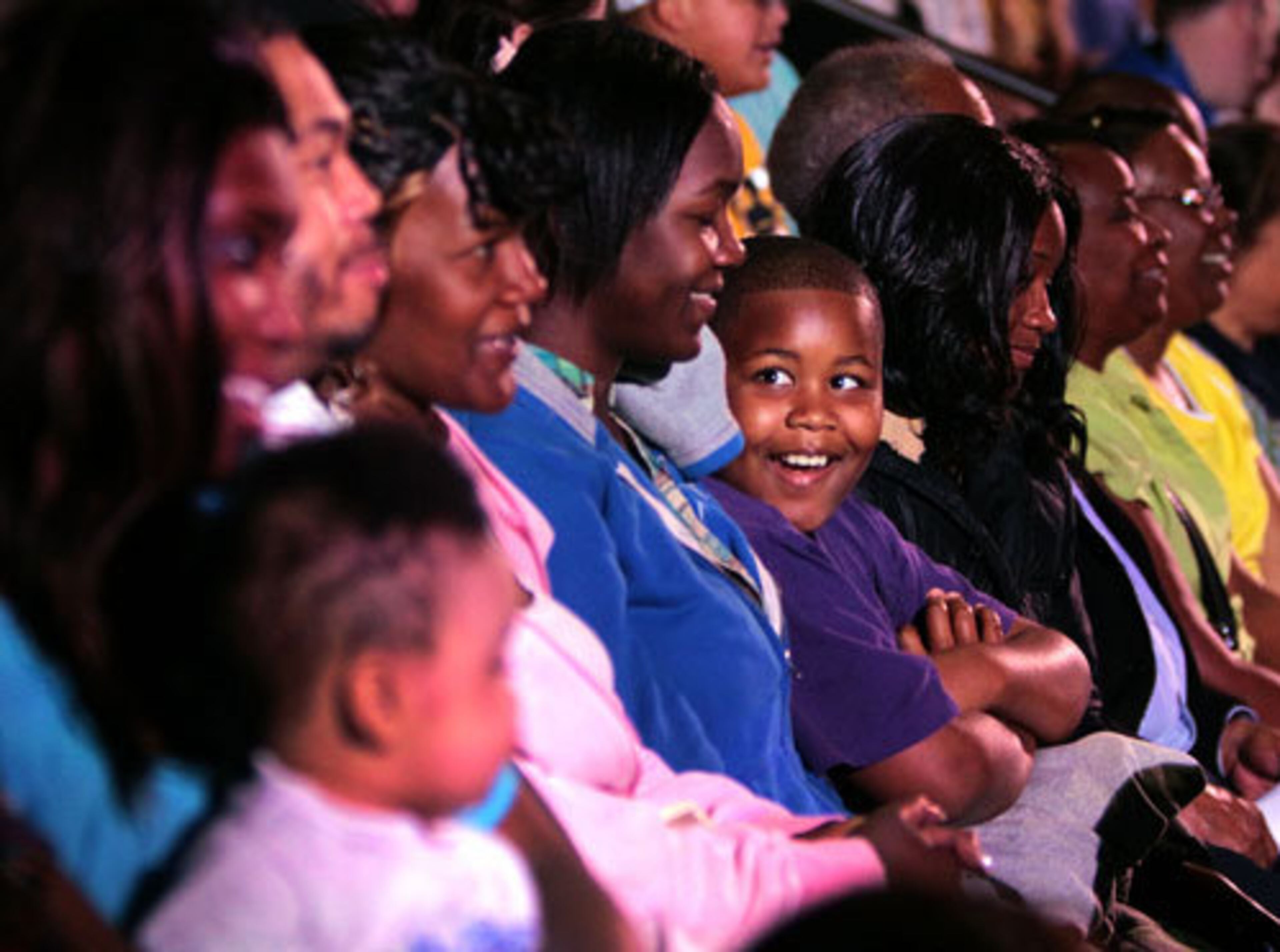 The audience marvels at the dolphins during their first performance at the Georgia Aquarium.
