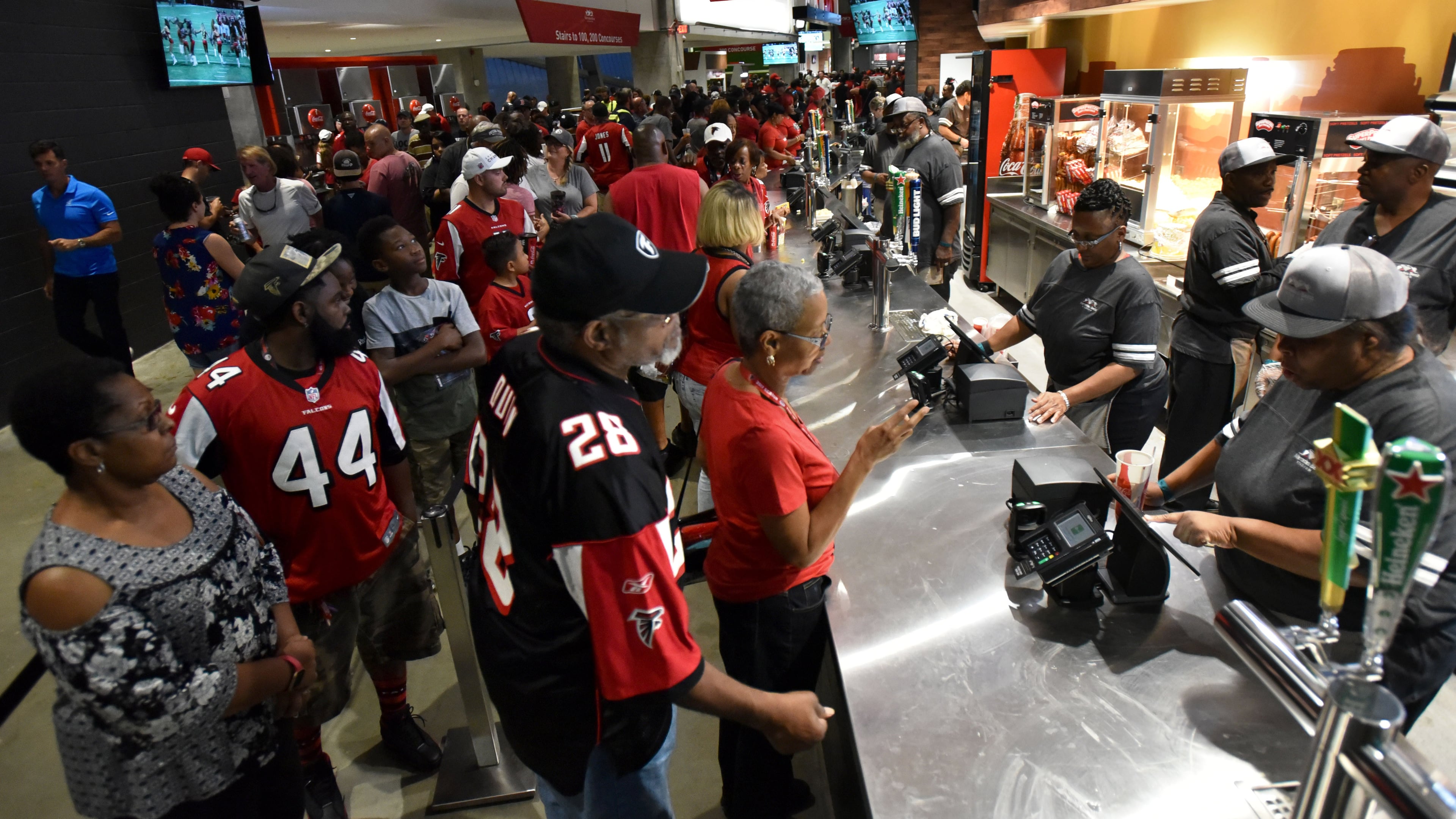 Long lines of fans wait to buy foods during the exhibition game between Atlanta Falcons and Arizona Cardinals at the new Mercedes-Benz Stadium Saturday, Aug. 26, 2017.