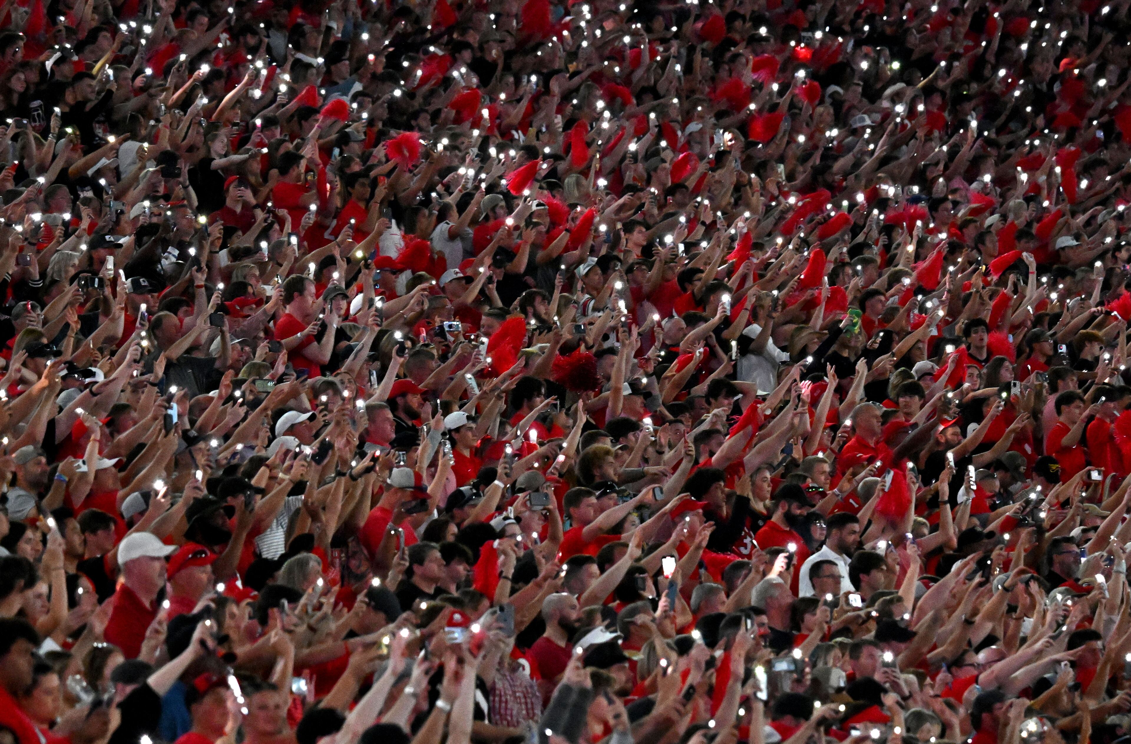 Georgia fans celebrate at the start of the fourth quarter as Sanford Stadium goes red in an NCAA football game against the UAB at Sanford Stadium, Saturday, September 23, 2023, in Athens. Georgia won 42-21 over UAB. (Hyosub Shin / Hyosub.Shin@ajc.com)