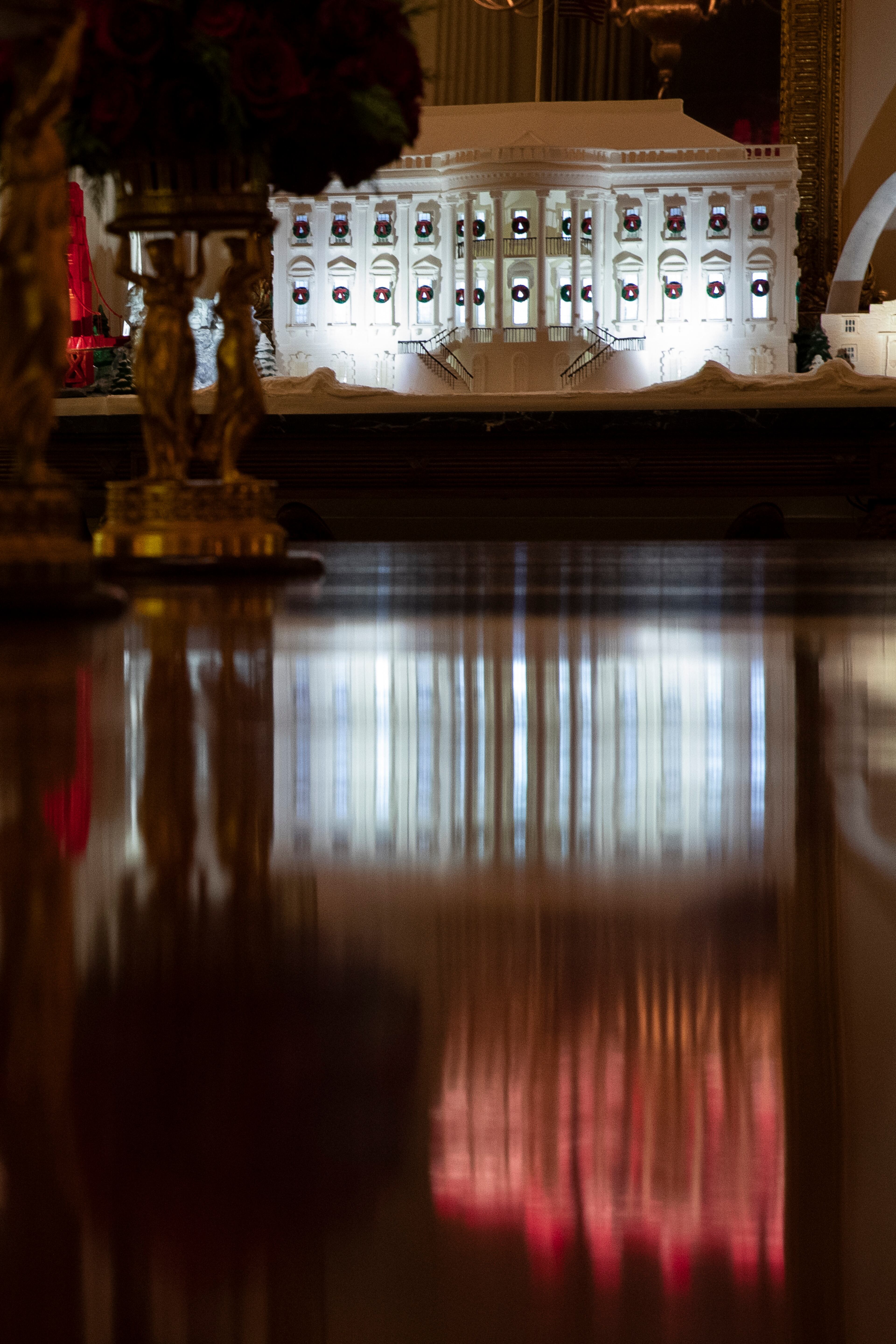 A White House made of gingerbread also features landmarks from around the country in the State Dinning Room during the 2019 Christmas preview at the White House, Monday, Dec. 2, 2019, in Washington. (AP Photo/Alex Brandon)