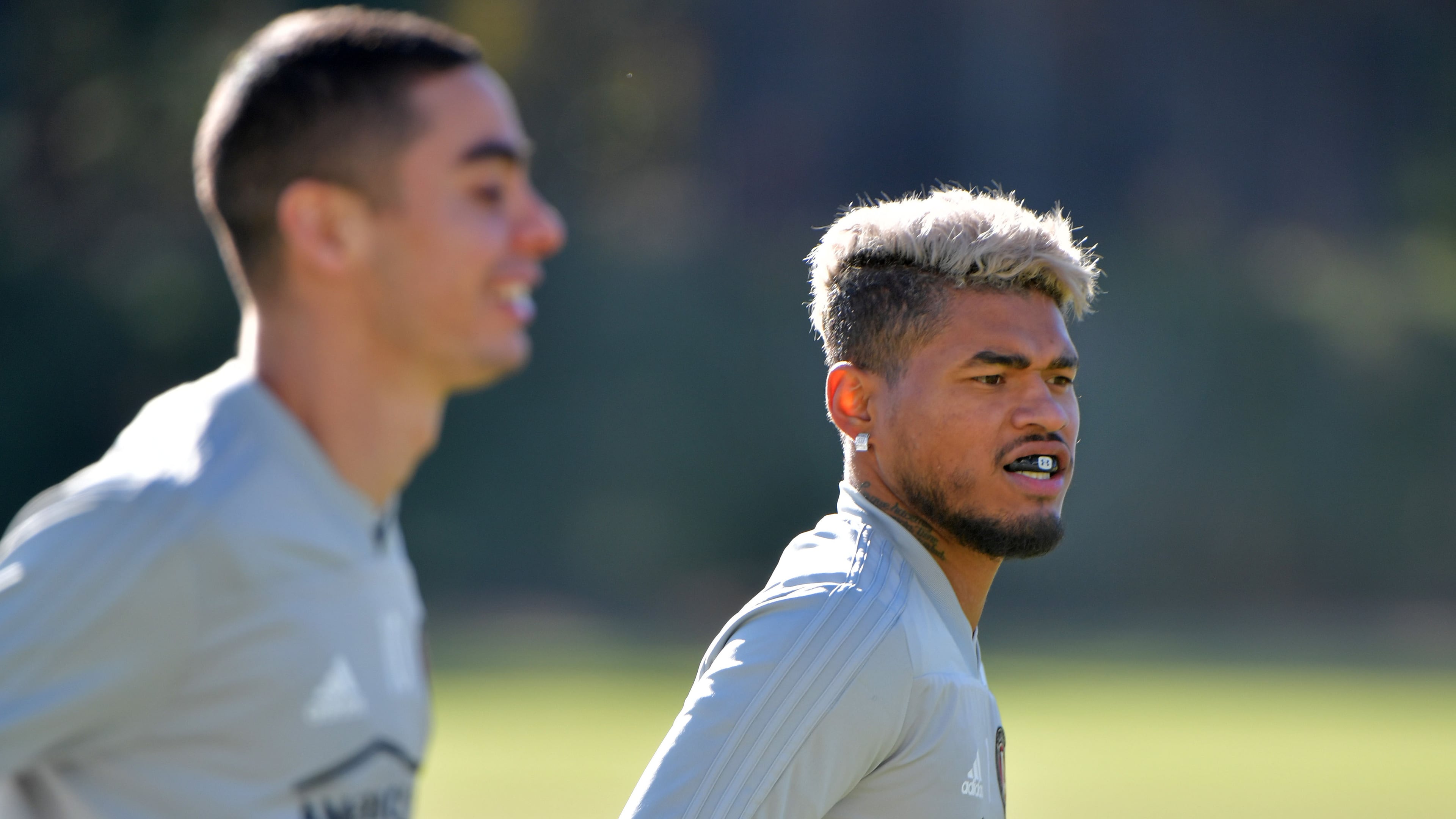 Midfielder Miguel Almiron (left) and forward Josef Martinez warm up during Tuesday's practice at Children's Healthcare of Atlanta Training Ground in Marietta. (Hyosub Shin/hshin@ajc.com)