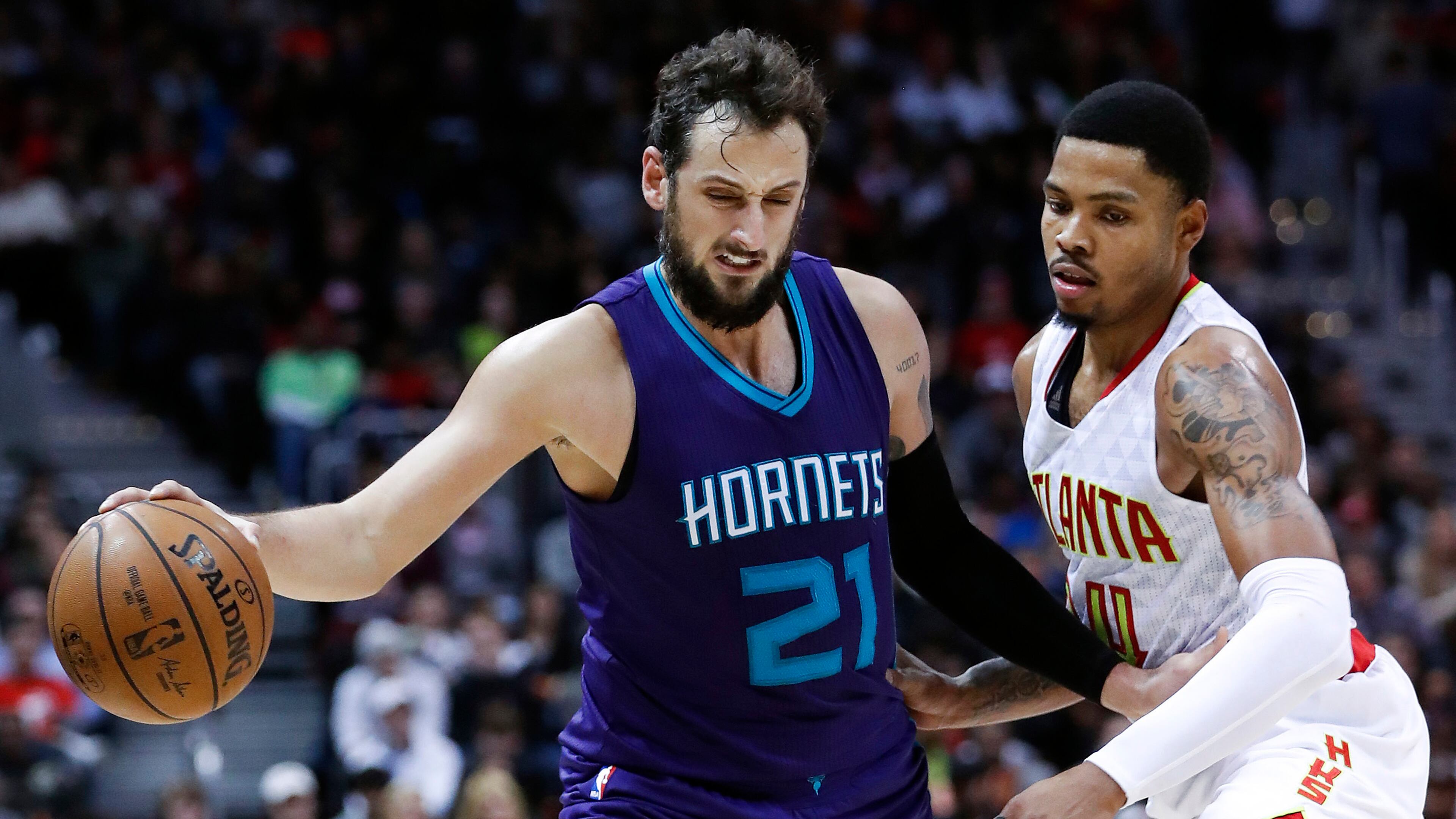 Charlotte Hornets guard Marco Belinelli (21) works against Atlanta Hawks forward Kent Bazemore (24) in the second half of an NBA basketball game Saturday, Dec. 17, 2016, in Atlanta. (AP Photo/John Bazemore)