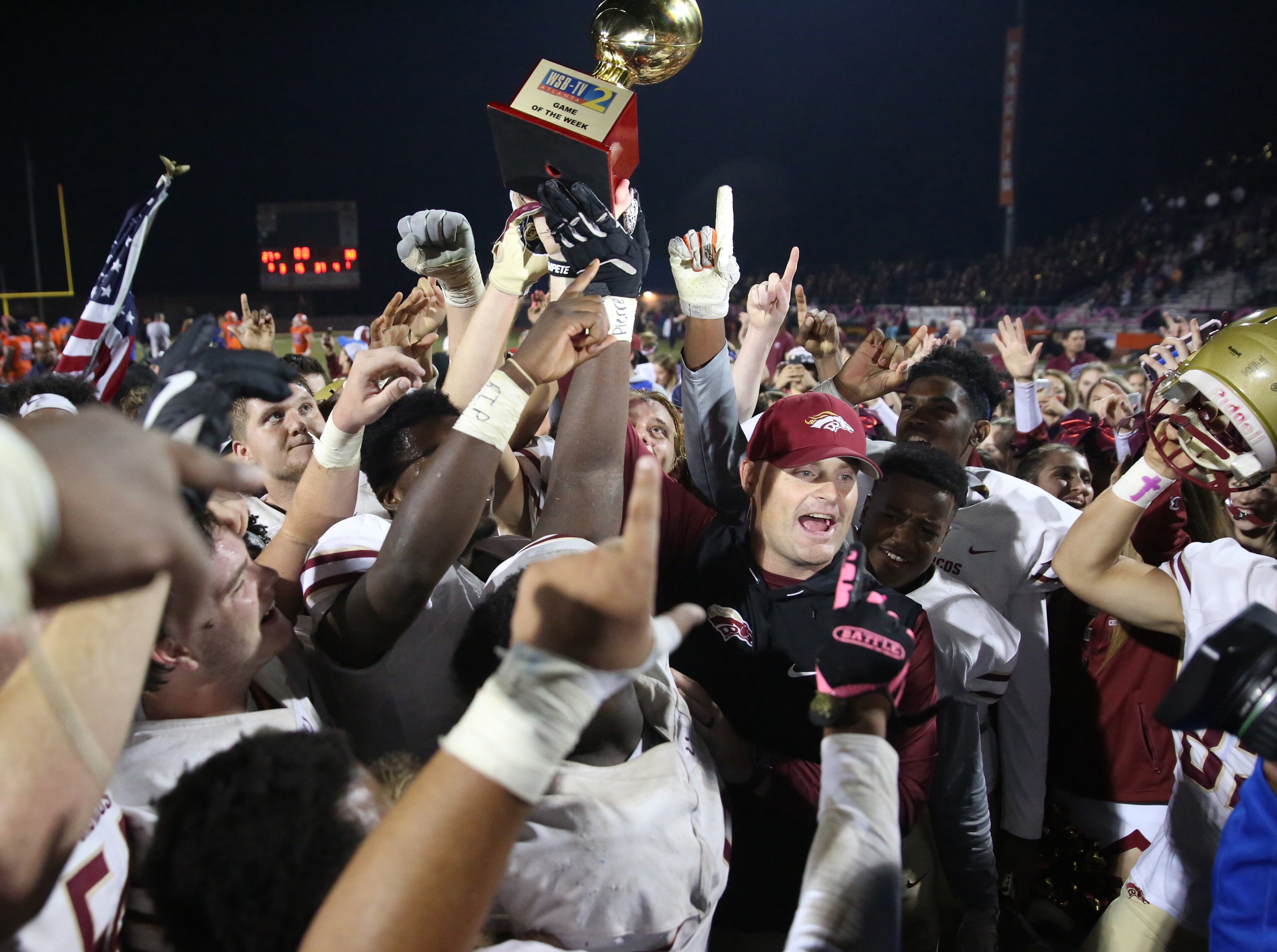 October 20, 2017 - Lilburn, Ga: Brookwood head coach Philip Jones receives a trophy as they celebrate their win against Parkview at Parkview High School Friday, October 20, 2017, in Lilburn, Ga.. Brookwood won 30-27. PHOTO / JASON GETZ