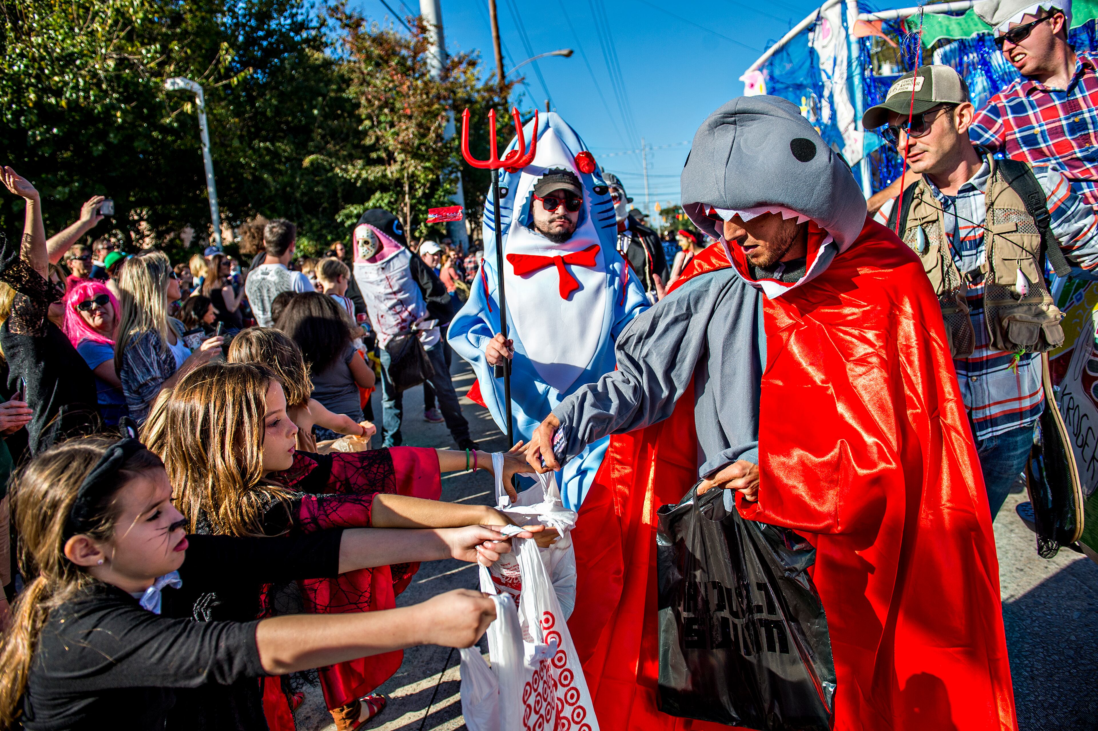 October 17, 2015 Atlanta - Adam Moore (right) passes out candy during the Little Five Points Halloween Parade in Atlanta on Saturday, October 17, 2015. The annual parade brought out tens of thousands of people to watch the antics. JONATHAN PHILLIPS / SPECIAL
