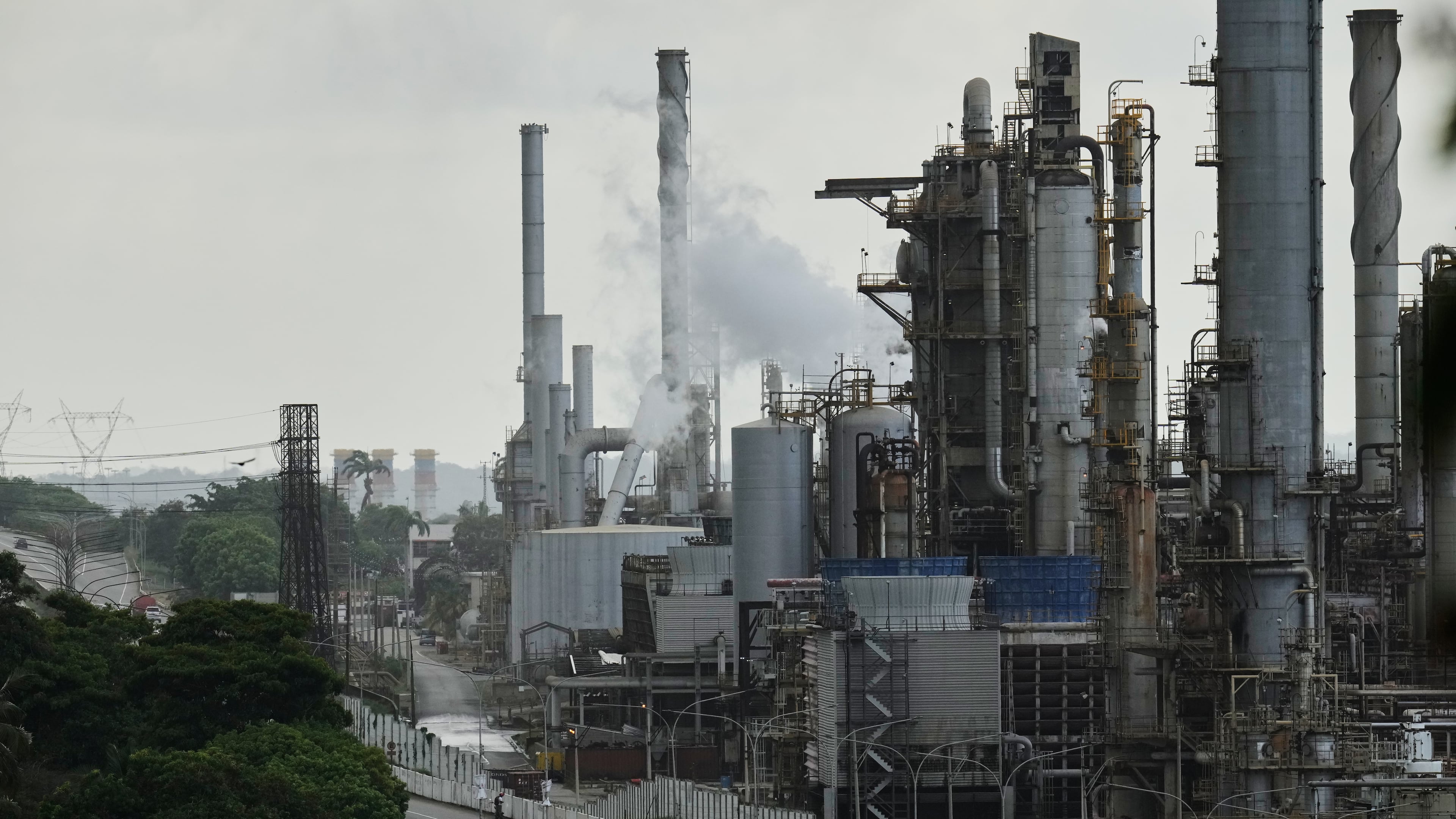 FILE - Vehicles drive past the El Palito oil refinery in Puerto Cabello, Venezuela, Dec. 21, 2025. (AP Photo/Matias Delacroix, File)