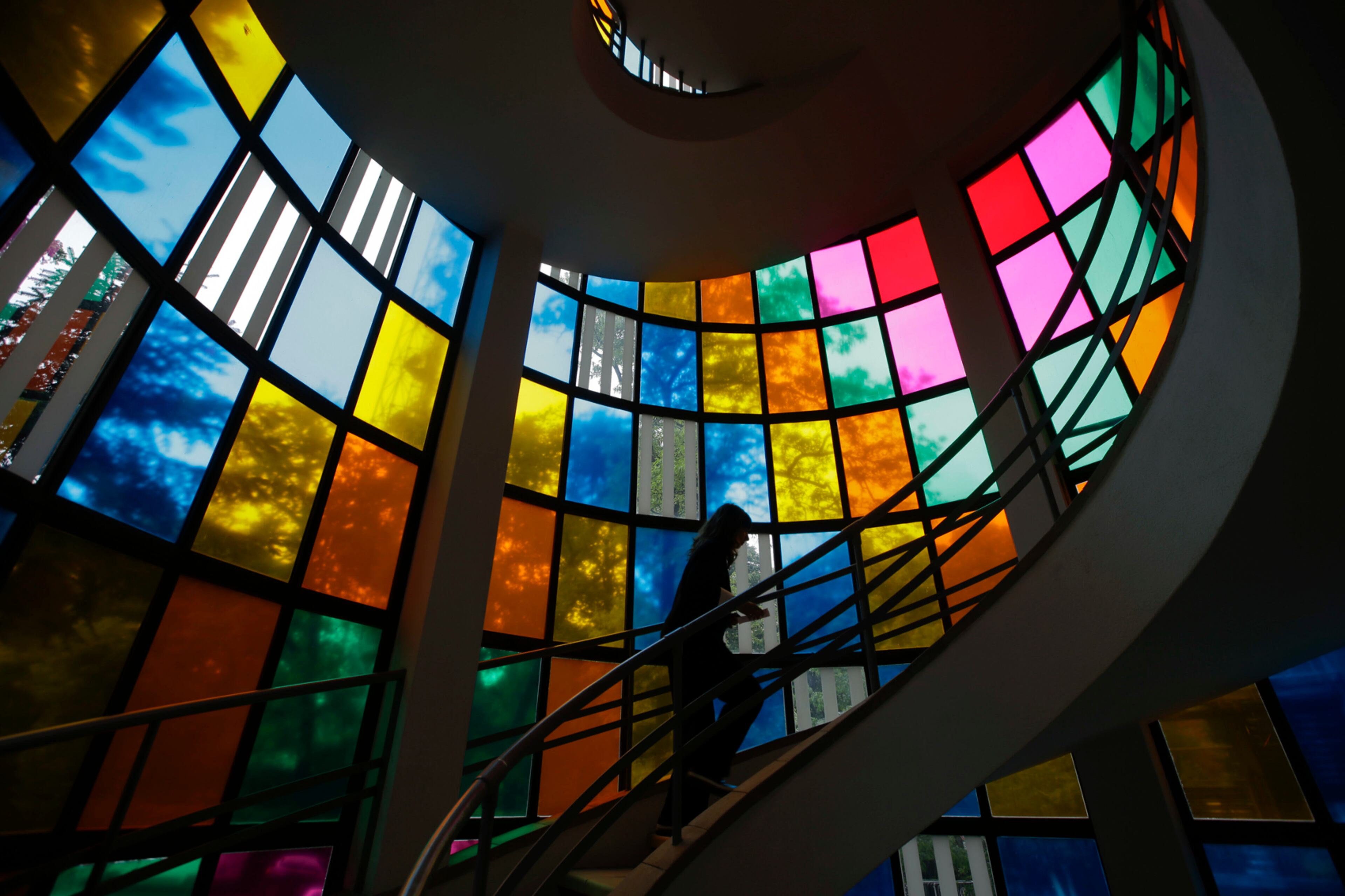 A woman climbs stairs at the Triennale palace of Arts, in Milan, Italy, Thursday, April 27, 2017. (AP Photo/Luca Bruno)