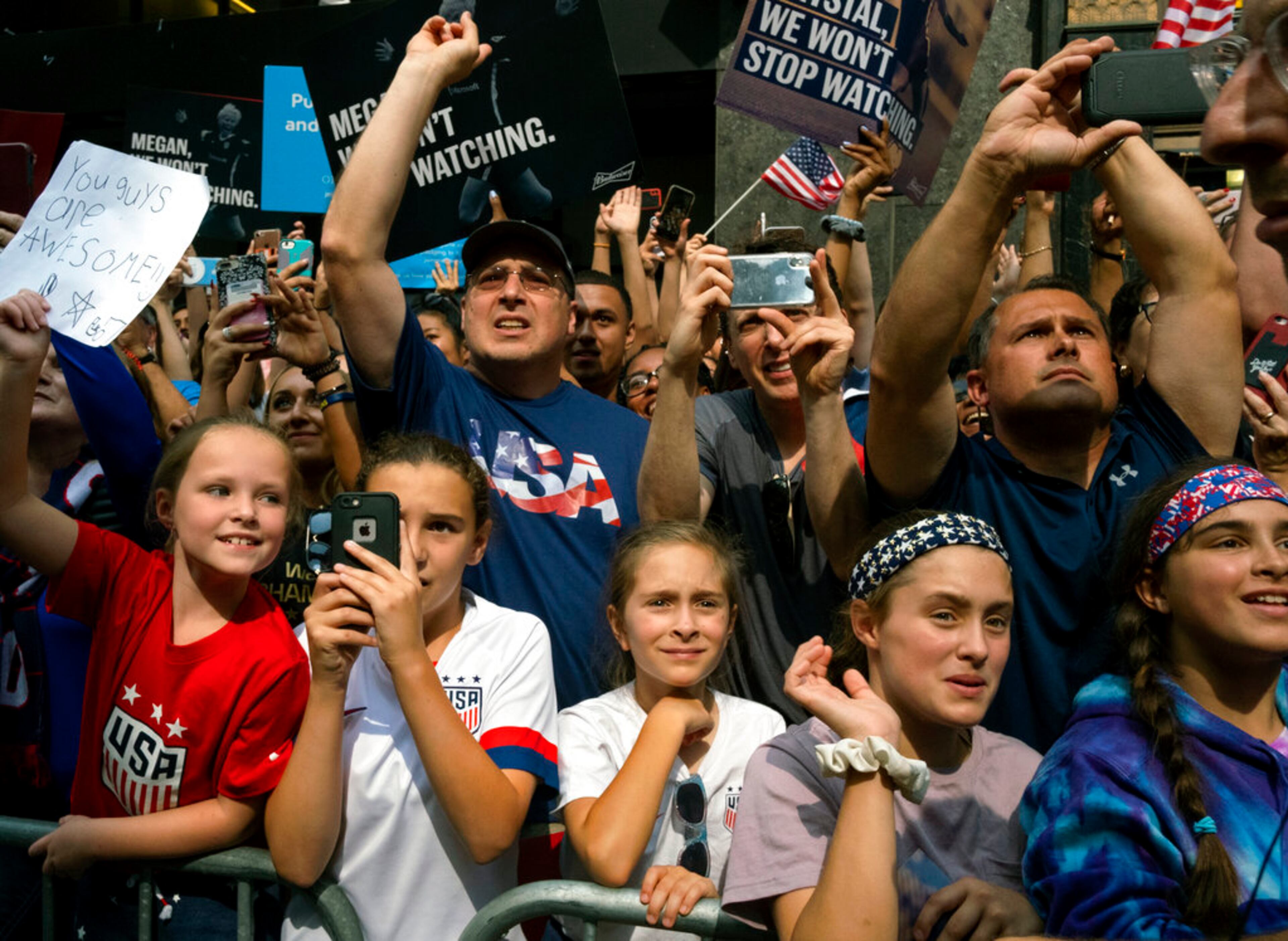 Fans celebrates as members of the the U.S. women's soccer team pass by during a ticker tape parade along the Canyon of Heroes, Wednesday, July 10, 2019, in New York. The U.S. national team beat the Netherlands 2-0 to capture a record fourth Women's World Cup title.(AP Photo/Craig Ruttle)