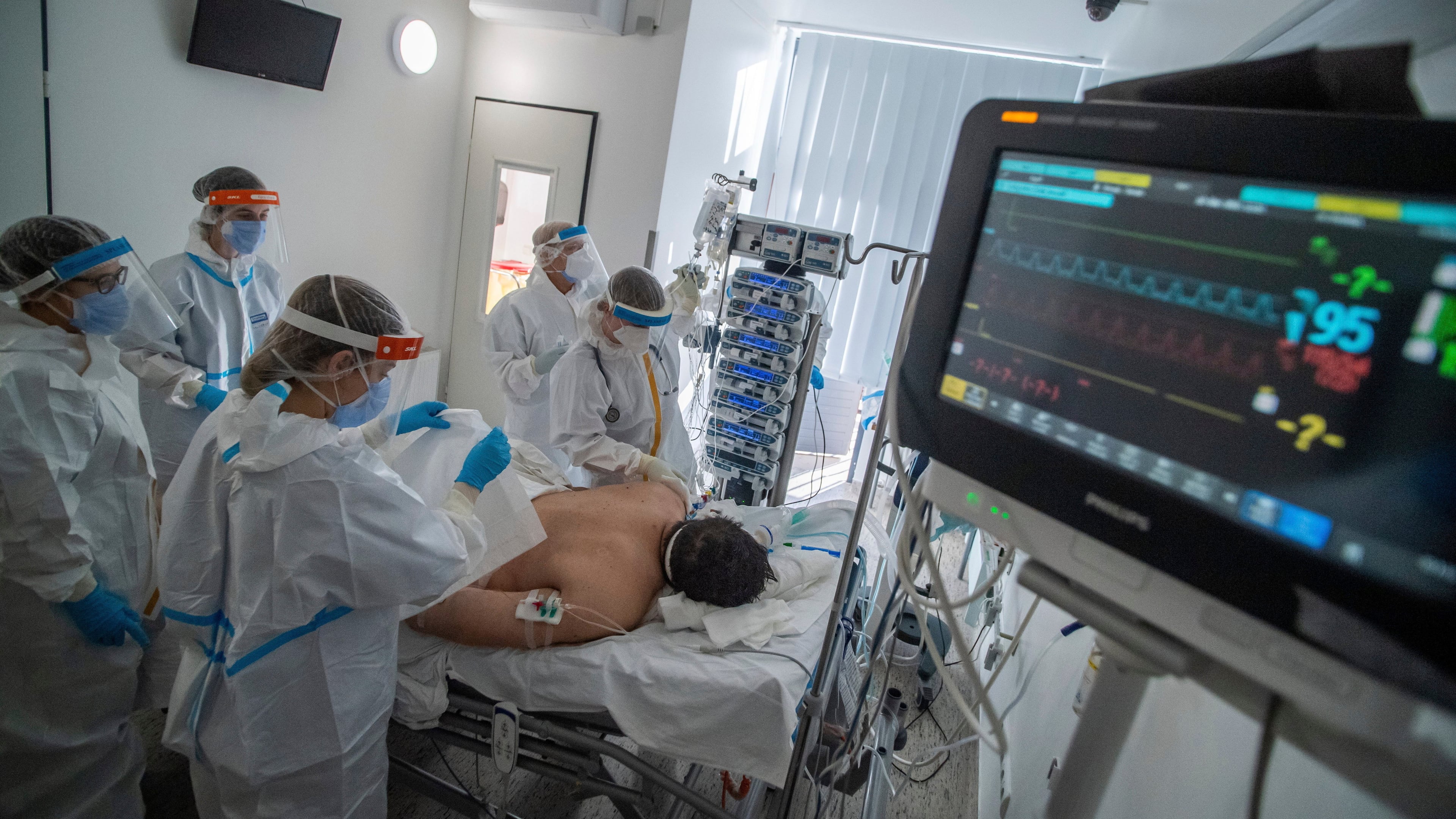 FILE - Doctors and nurses wearing protective gears attend a patient on ventilator at the intensive care unit of Szent Laszlo Hospital treating COVID-19 patients during the pandemic of new coronavirus COVID-19 in Budapest, Hungary, on Dec. 13, 2021. (Zoltan Balogh/MTI via AP, File)