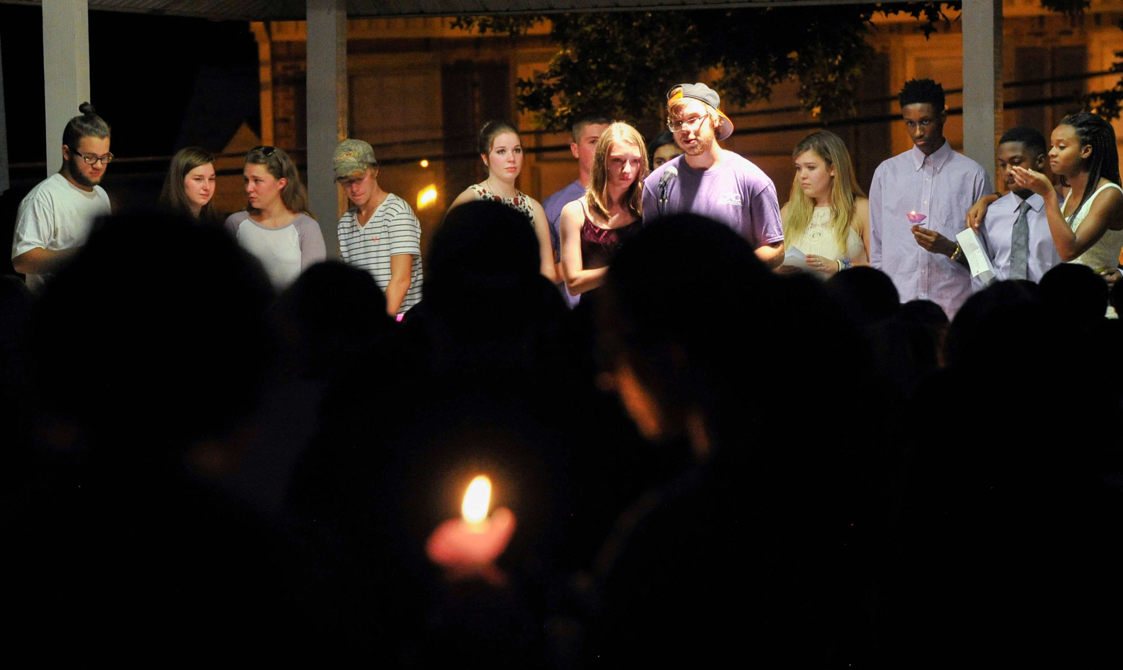 Friends of Natalie Henderson speak during a vigil held for her on the old Roswell Square, Thursday, Aug. 4, 2016. Henderson, of Roswell, and Carter Davis of Woodstock, both 17, were found Monday behind a Publix grocery store shot to death. Jeffrey A. Hazelwood, 20, was arrested Wednesday and will be charged with two counts of murder in the deaths. (Photo Contributed by John Amis)