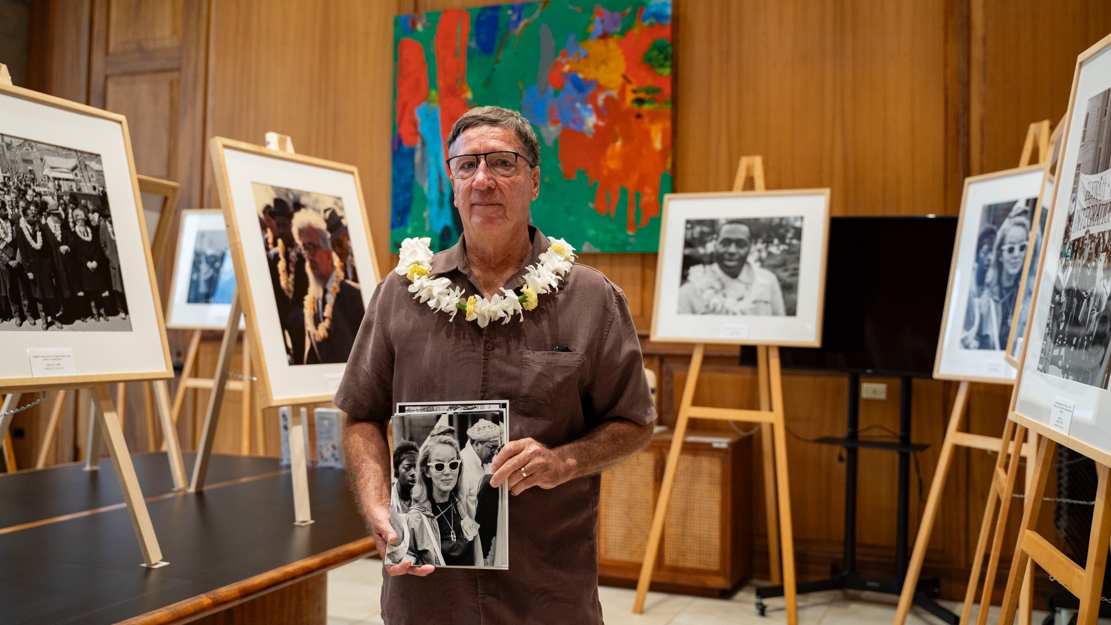 Steven Springel holds a photograph of his mother, Nona Springel Ferdon, a member of Hawaii's delegation to the 1965 Selma-to-Montgomery march, during the opening of a Martin Luther King Jr. photo exhibit at the Hawaii State Capitol, Tuesday, June 30, 2026, in Honolulu. (AP Photo/Mengshin Lin)