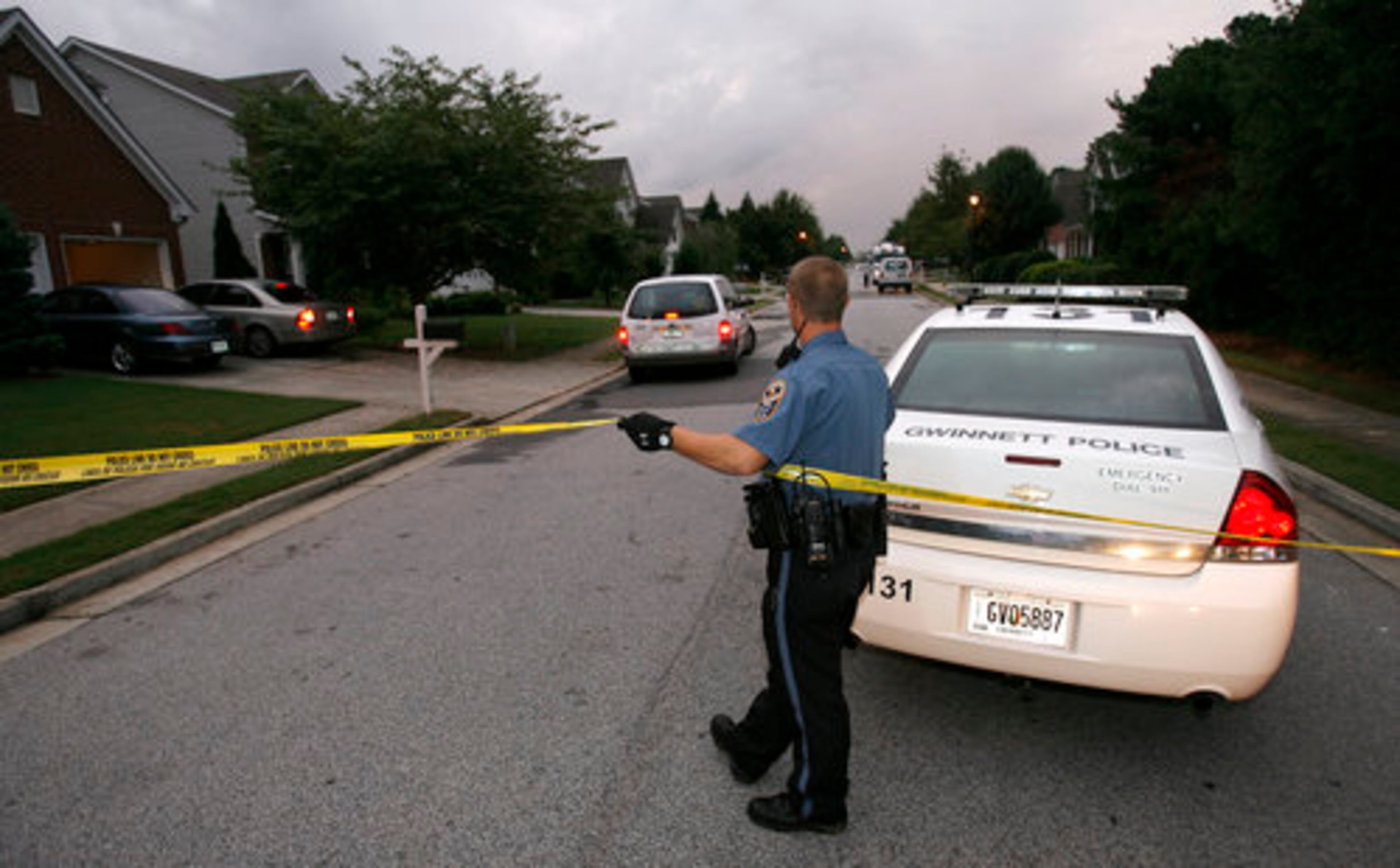 A Gwinnett County Police officer secures the perimeter along Clairidge Lane early Friday morning after a quadruple shooting. Richard Ringold, 44, is accused of fatally shooting four people and injuring a four-year-old girl in the 700 block of Clairidge Lane in Lawrenceville.