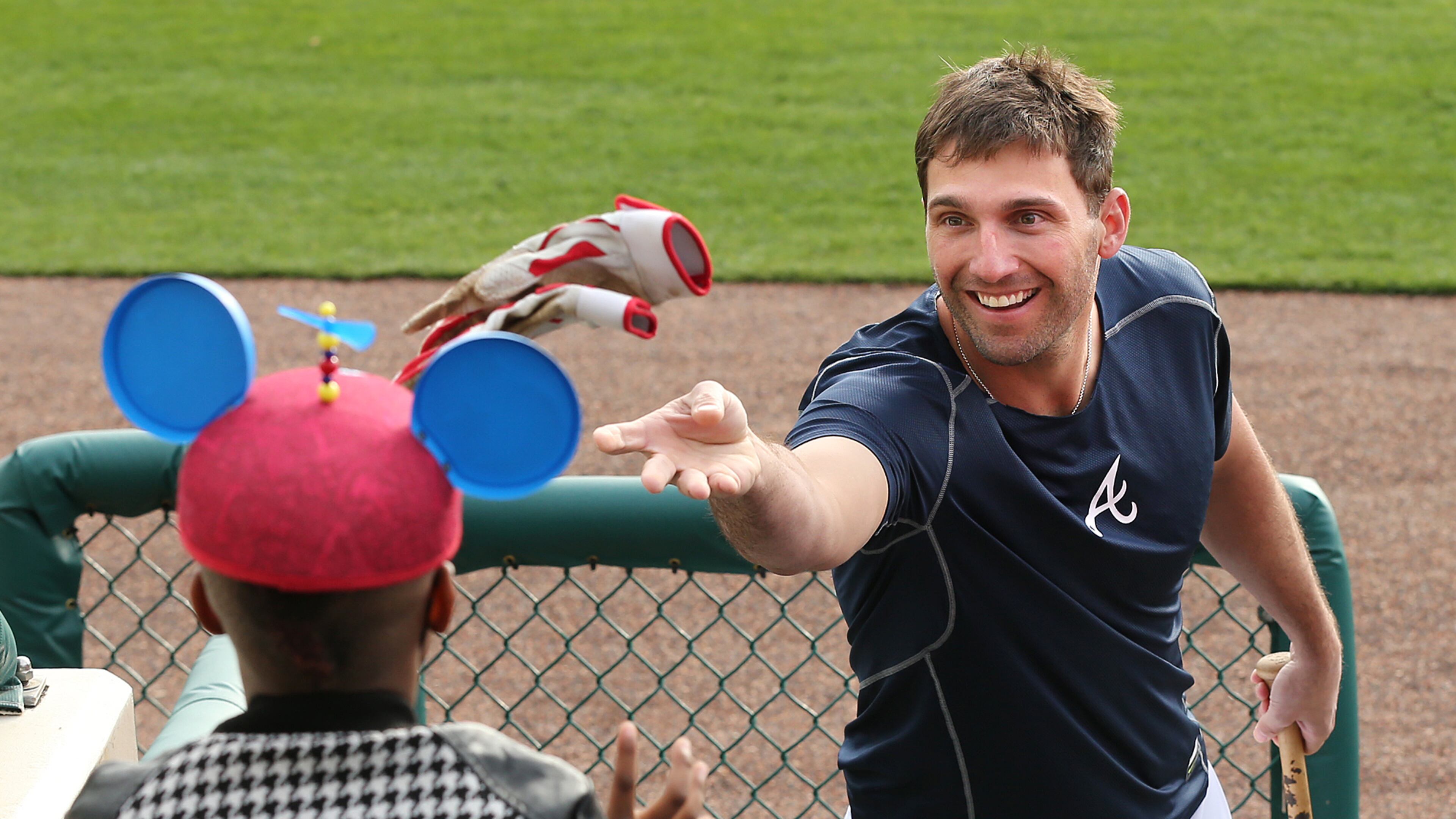 022516 LAKE BUENA VISTA: Braves outfielder Jeff Francoeur tosses his batting gloves to 7-year-old Keion Mathis during spring training at Champion Stadium on Thursday, Feb 25, 2016, at the ESPN Wide World of Sports, Lake Buena Vista, FL. Curtis Compton / ccompton@ajc.com