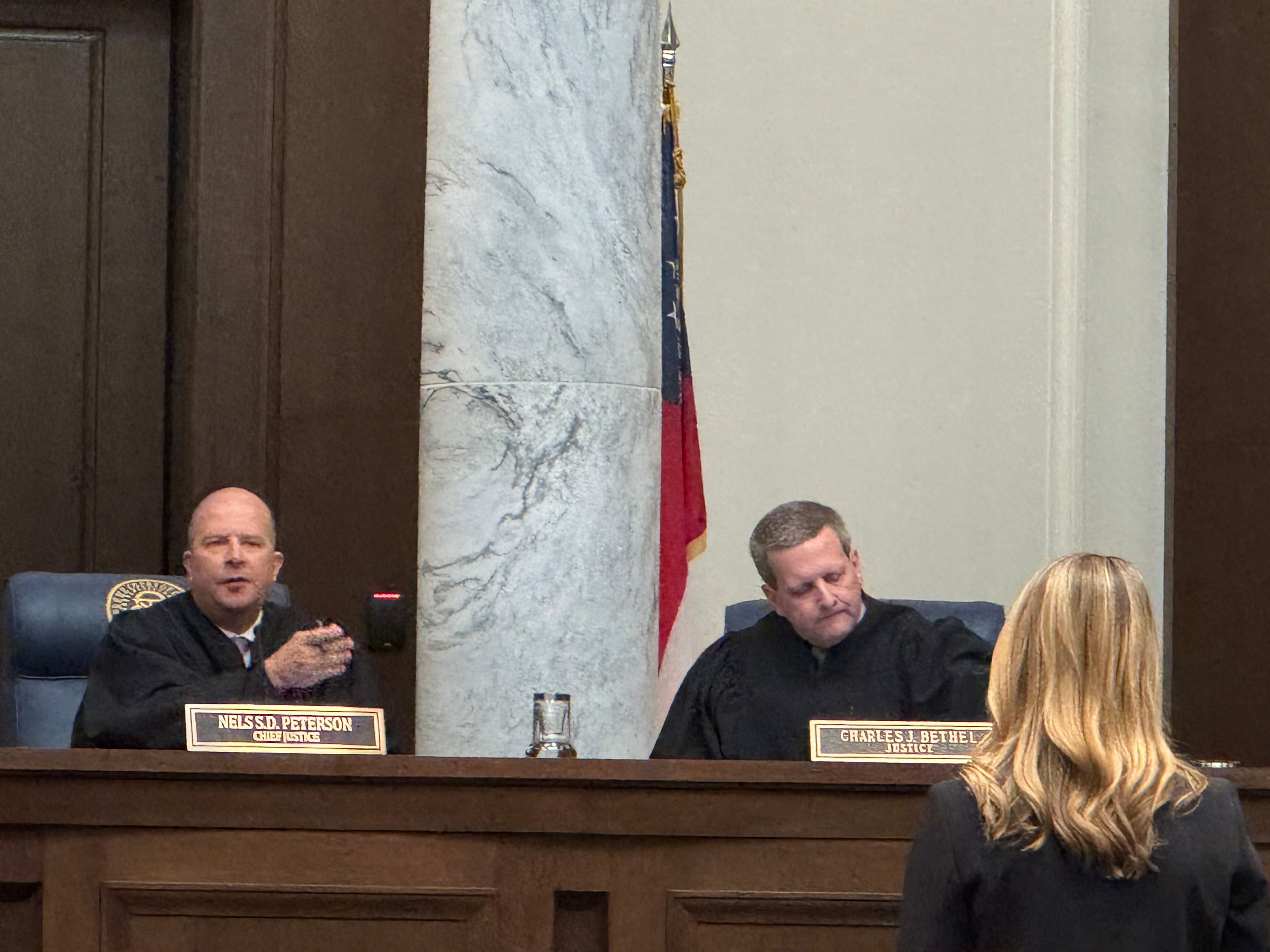 Georgia Supreme Court Chief Justice Nels S. D. Peterson (left) asked an attorney a question during an August hearing in Atlanta.