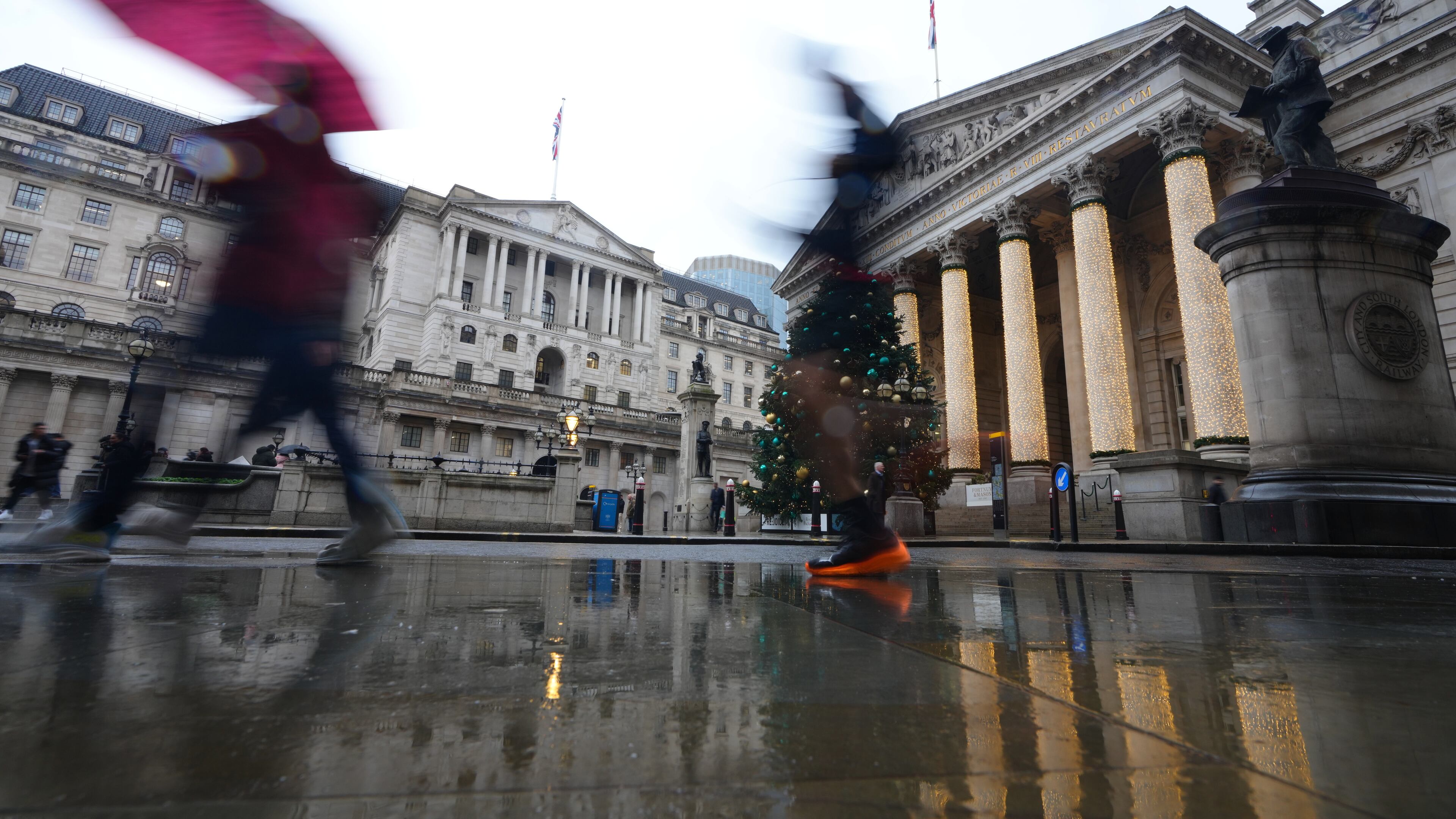 FILE - Pedestrians pass the Bank of England in London, on Dec. 18, 2025. (AP Photo/Kirsty Wigglesworth, File)