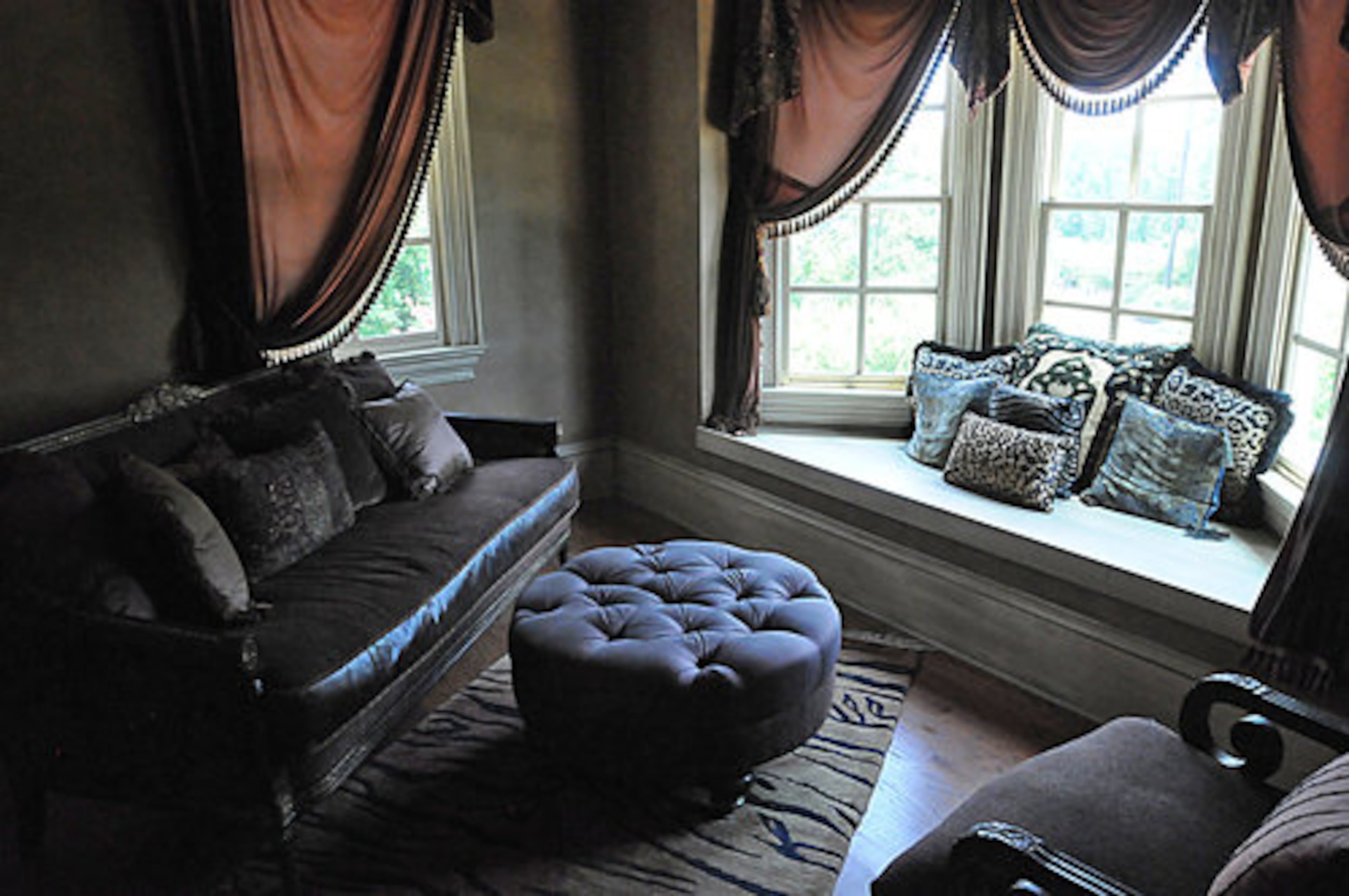 This cozy reading nook has a beautiful view to the outdoor area and provides plenty of natural light for curling up with a good book. The plush seating in this area encourages one to slow down and relax.