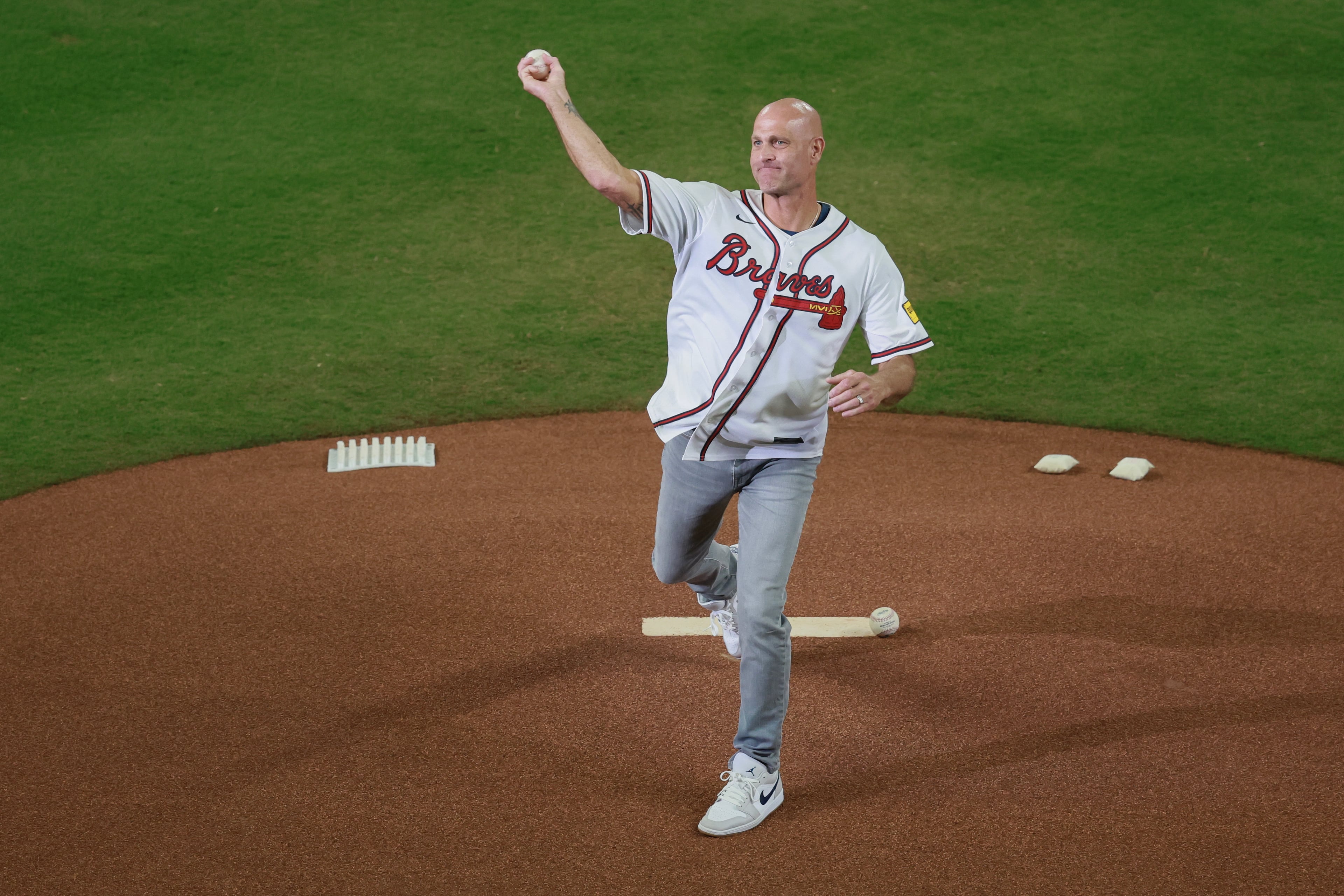 Former Atlanta Braves pitcher Tim Hudson throws out the ceremonial first pitch before Game 3 of a MLB National League Wild Card playoff series between the Atlanta Braves and the Philadelphia Phillies, Thursday, Oct. 1, 2026, in Atlanta. (Jason Getz/AJC)