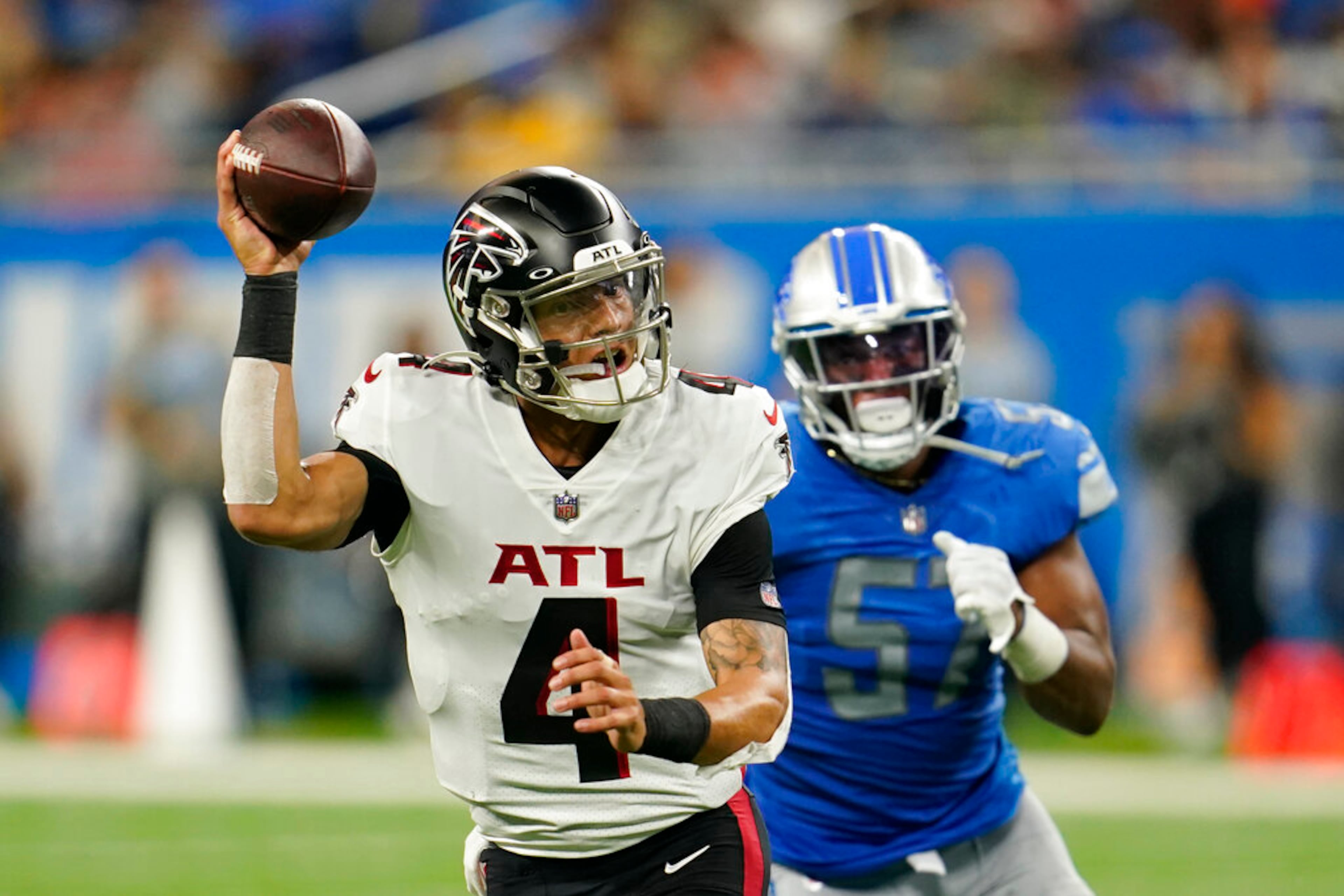 Atlanta Falcons quarterback Desmond Ridder (4) scrambles during the second half of a preseason NFL football game against the Detroit Lions, Friday, Aug. 12, 2022, in Detroit. (AP Photo/Paul Sancya)