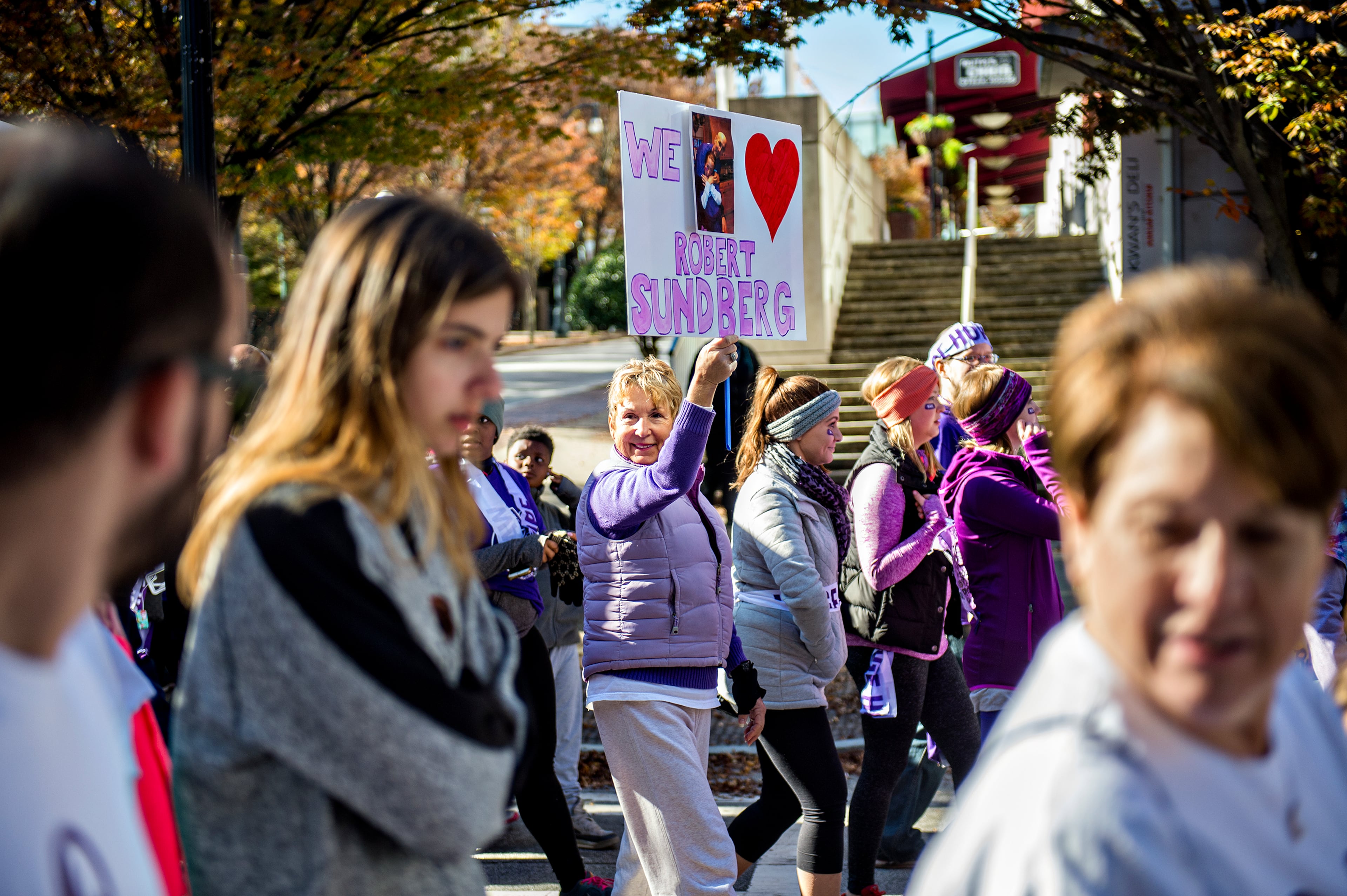 November 14, 2015 Atlanta - Becca Sadri (center) holds up a sign in memory of Robert Sundberg as she walks in the PurpleStride Atlanta 5k at Centennial Olympic Park in Atlanta on Saturday, November 14, 2015. Participants raised over $265,000 for the Pancreatic Cancer Action Network. JONATHAN PHILLIPS / SPECIAL