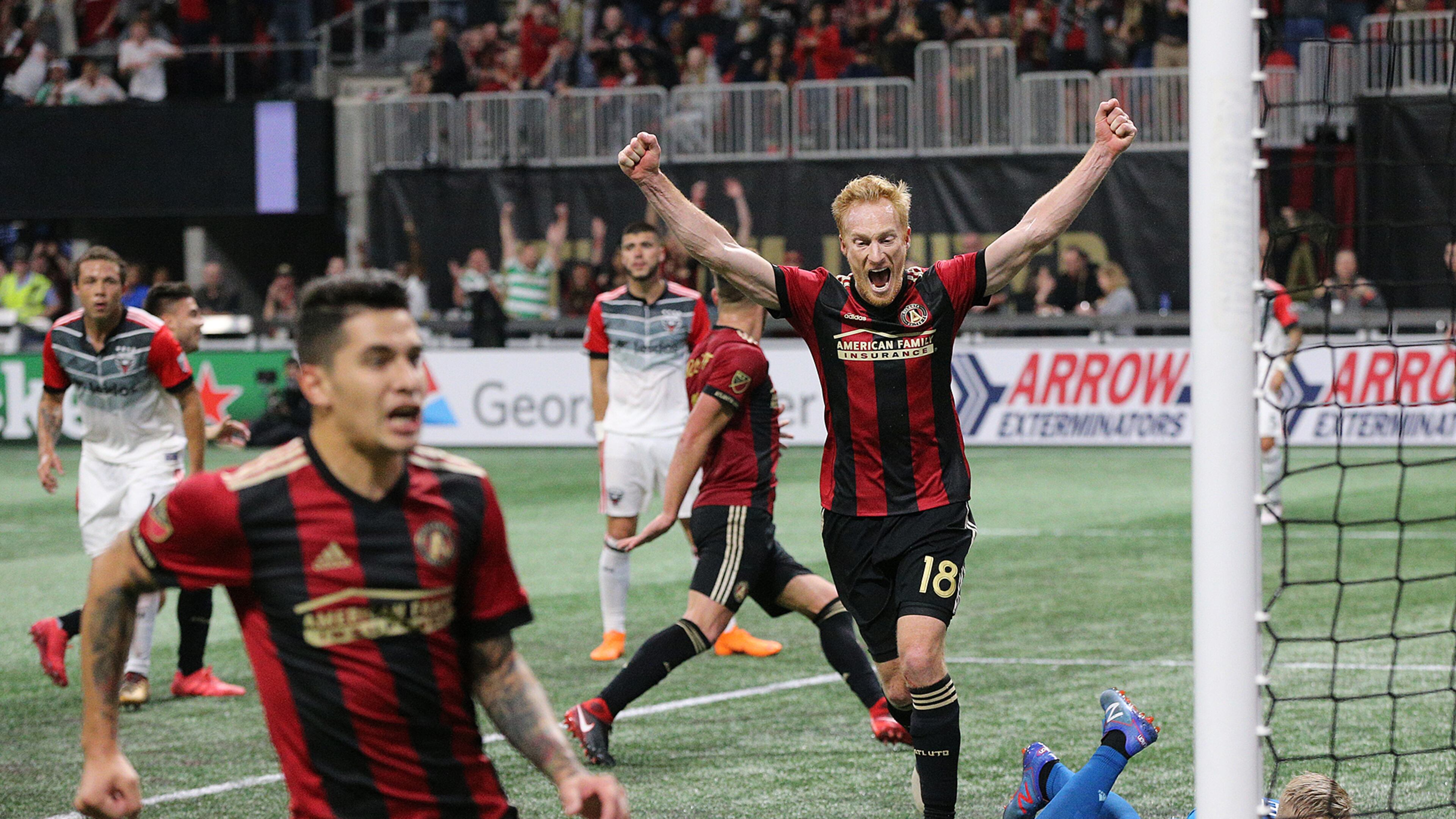 Atlanta United midfielder Jeff Larentowiz (center) and teammates react as a shot by teammate Hector Villalba (far left) gets past D.C. United goalkeeper David Ousted for a 3-0 lead during the second half in a MLS soccer match on Sunday, March 11, 2018, in Atlanta. Atlanta United won the game 3-1. Curtis Compton/ccompton@ajc.com