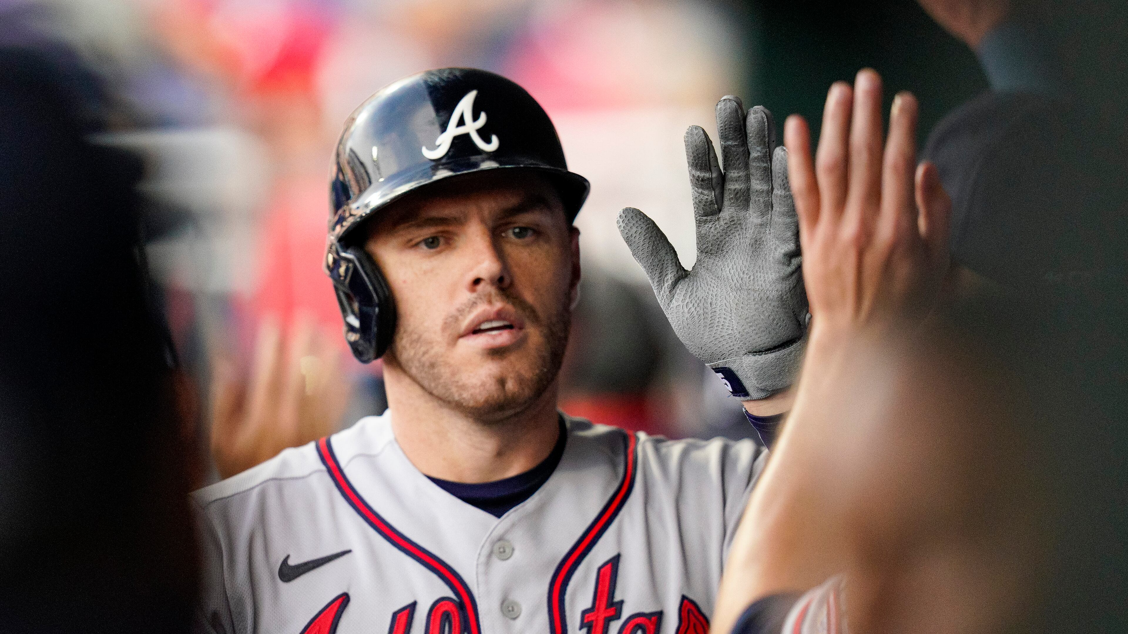 Atlanta Braves' Freddie Freeman is congratulated for his two-run home run during the first inning of the team's baseball game against the Philadelphia Phillies, Saturday, July 24, 2021, in Philadelphia. (AP Photo/Chris Szagola)