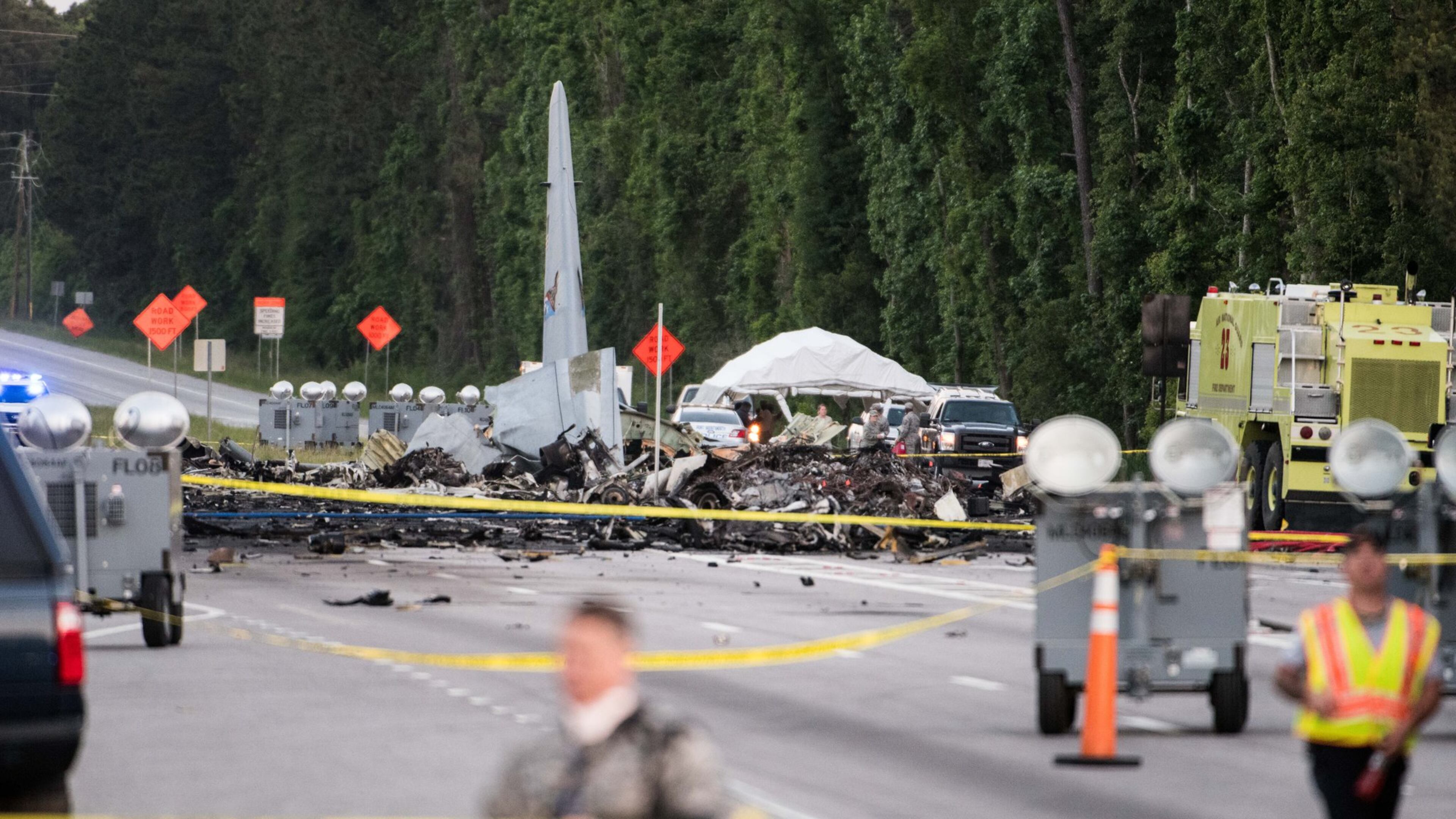 PORT WENTWORTH, GA - MAY 2: Emergency responders walk across Route 21 where an Air National Guard C-130 cargo plane crashed May 2, 2018 in Port Wentworth, Georgia. The 50-year-old plane, belonging to the Puerto Rico Air National Guard, crashed near the coastal city of Savannah on its way to Tuscon, Arizona, where it was to be decommissioned. All nine people aboard were killed. (Photo by Sean Rayford/Getty Images)