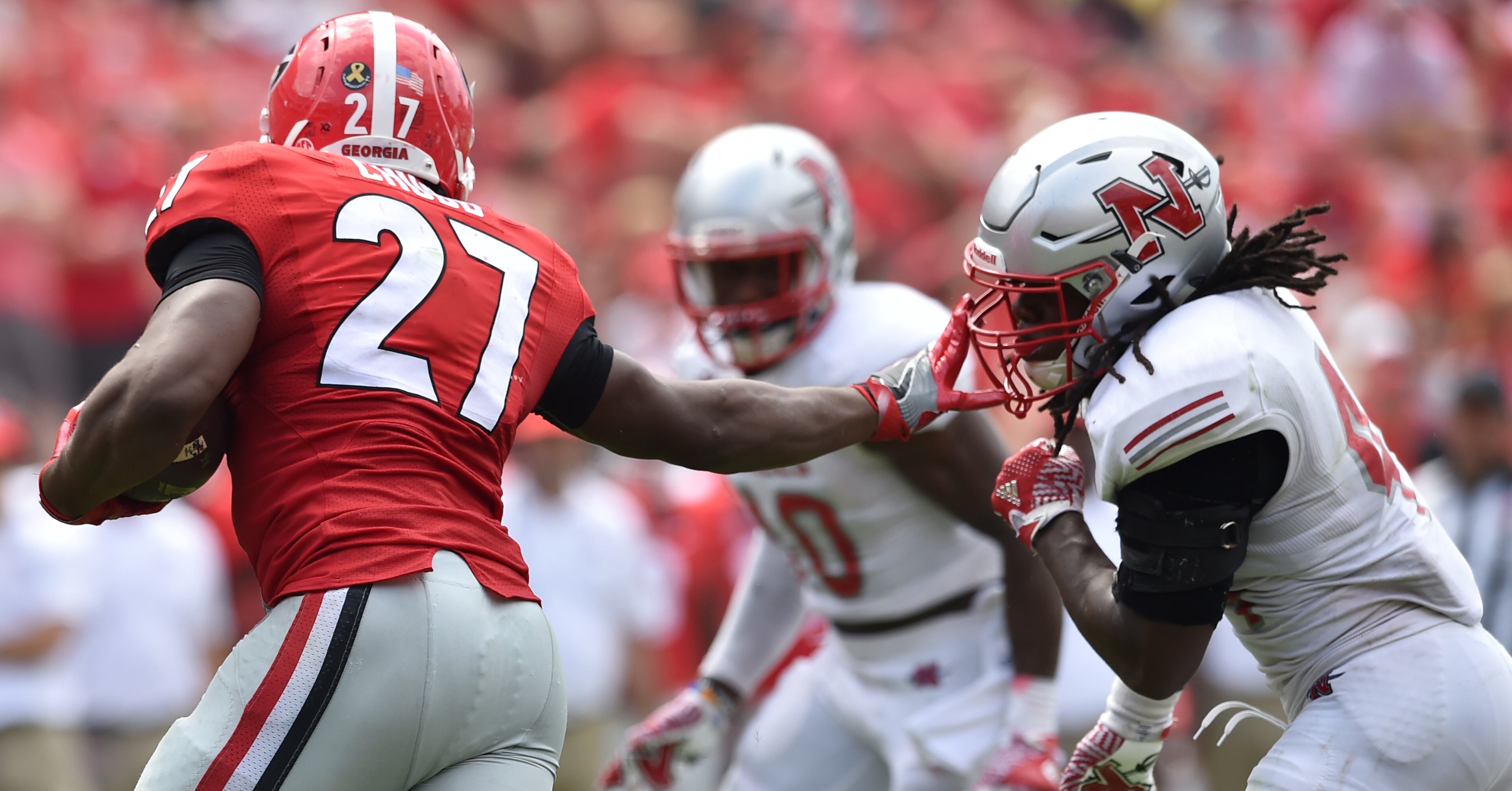 September 10, 2016 Athens, GA: Nick Chubb stiff arms Nicholls State Colonels defensive back Ahmani Martin during the 4th quarter at Sanford Stadium Saturday September 10, 2016. Chubb rushed for 80 yards and one touchdown in the 26-24 win over the Colonels. BRANT SANDERLIN/BSANDERLIN@AJC.COM