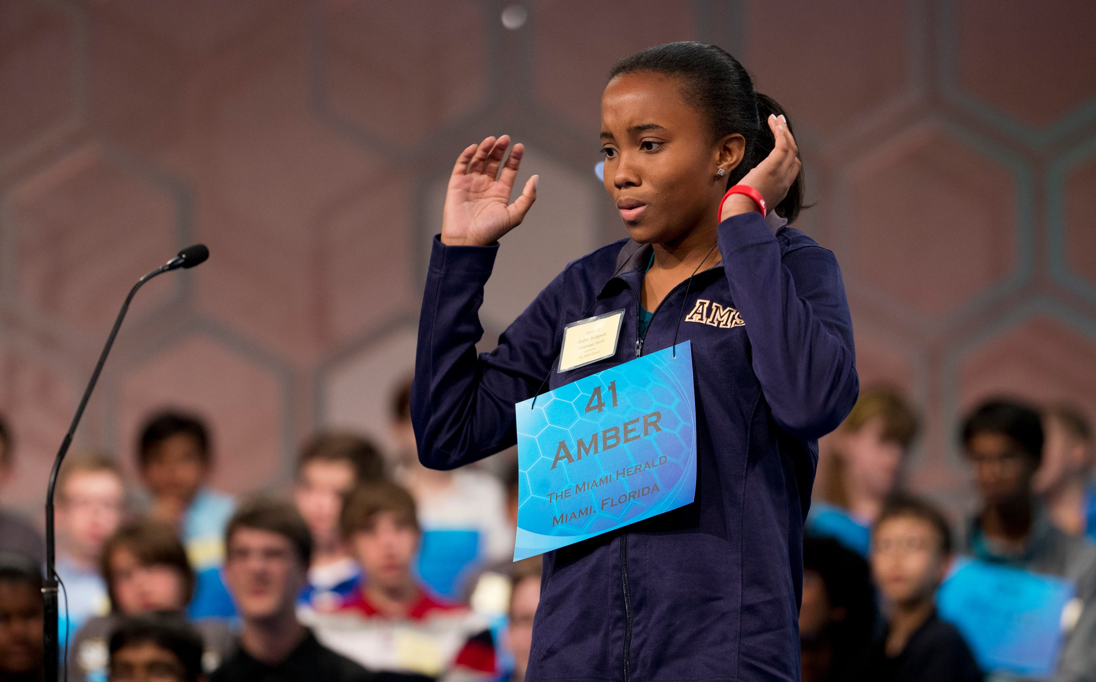 Eighth grade student Amber Robinson, 14, of Herbert A. Ammons Middle School, Miami, Fla., expresses her struggle to spell the word, "pelagial" during the preliminaries, round three of the Scripps National Spelling Bee, Wednesday, May 28, 2014, at National Harbor in Oxon Hill, Md. Robinson failed to spell the word correctly as she spelled it, polagial. (AP Photo/Manuel Balce Ceneta)