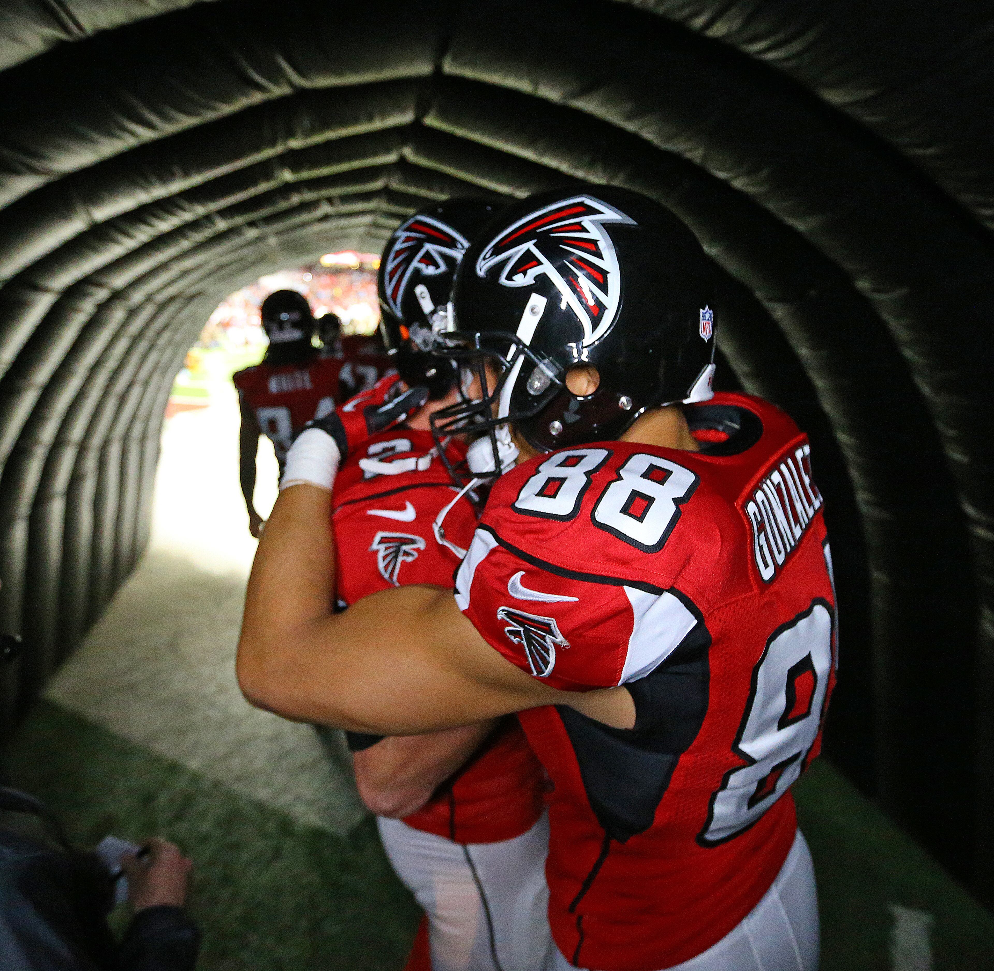 Falcons quarterback Matt Ryan hugs tight end Tony Gonzalez in the tunnel moments before he takes the field for the final game of his 17-year NFL career on Sunday, Dec. 29, 2013, in Atlanta.