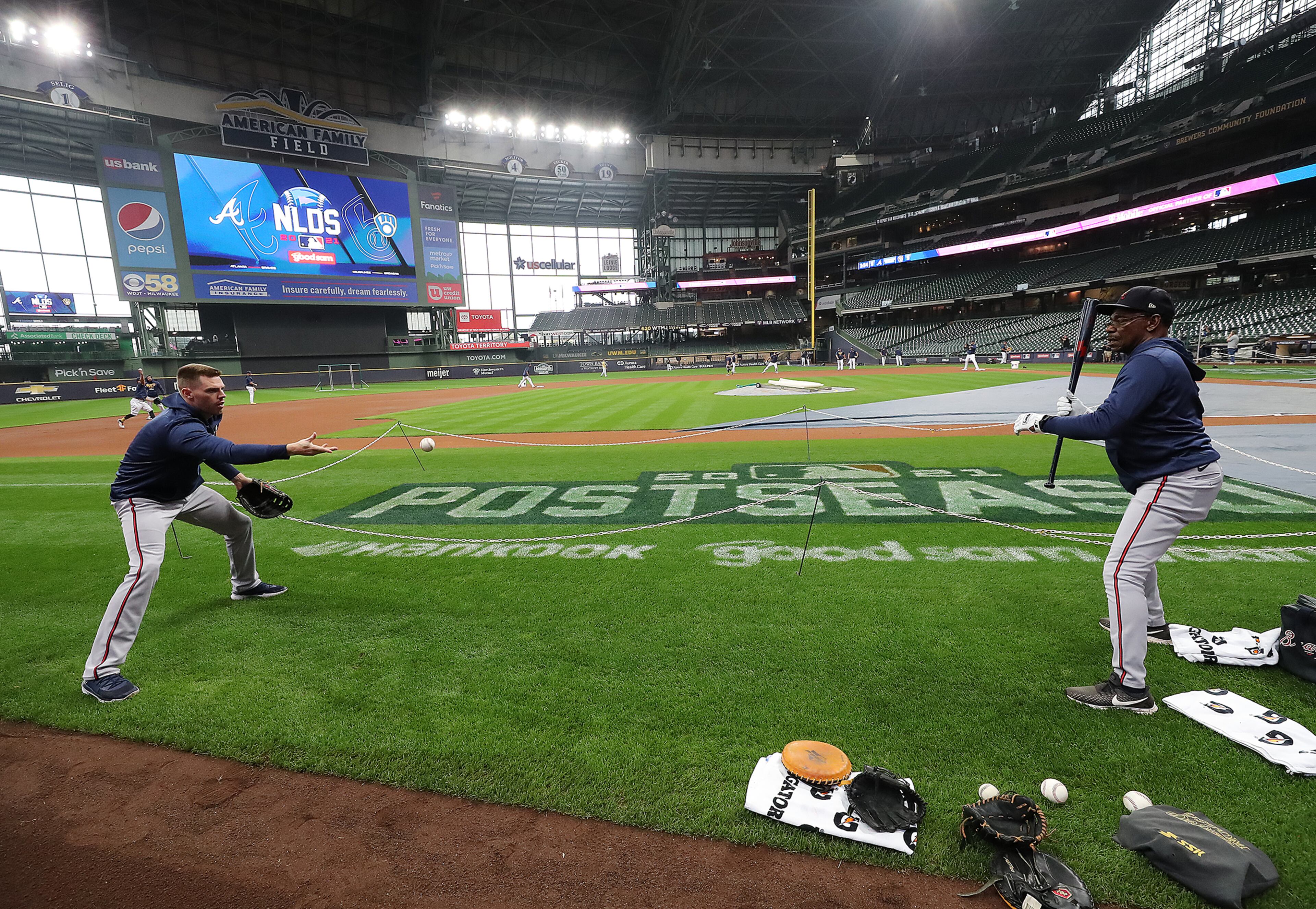 Braves first baseman Freddie Freeman takes grounders from third base coach Ron Washington at American Family Field during team practice while preparing to play the Milwaukee Brewers in the National League Division Series on Thursday, Oct. 7, 2021, in Milwaukee. “Curtis Compton / Curtis.Compton@ajc.com”