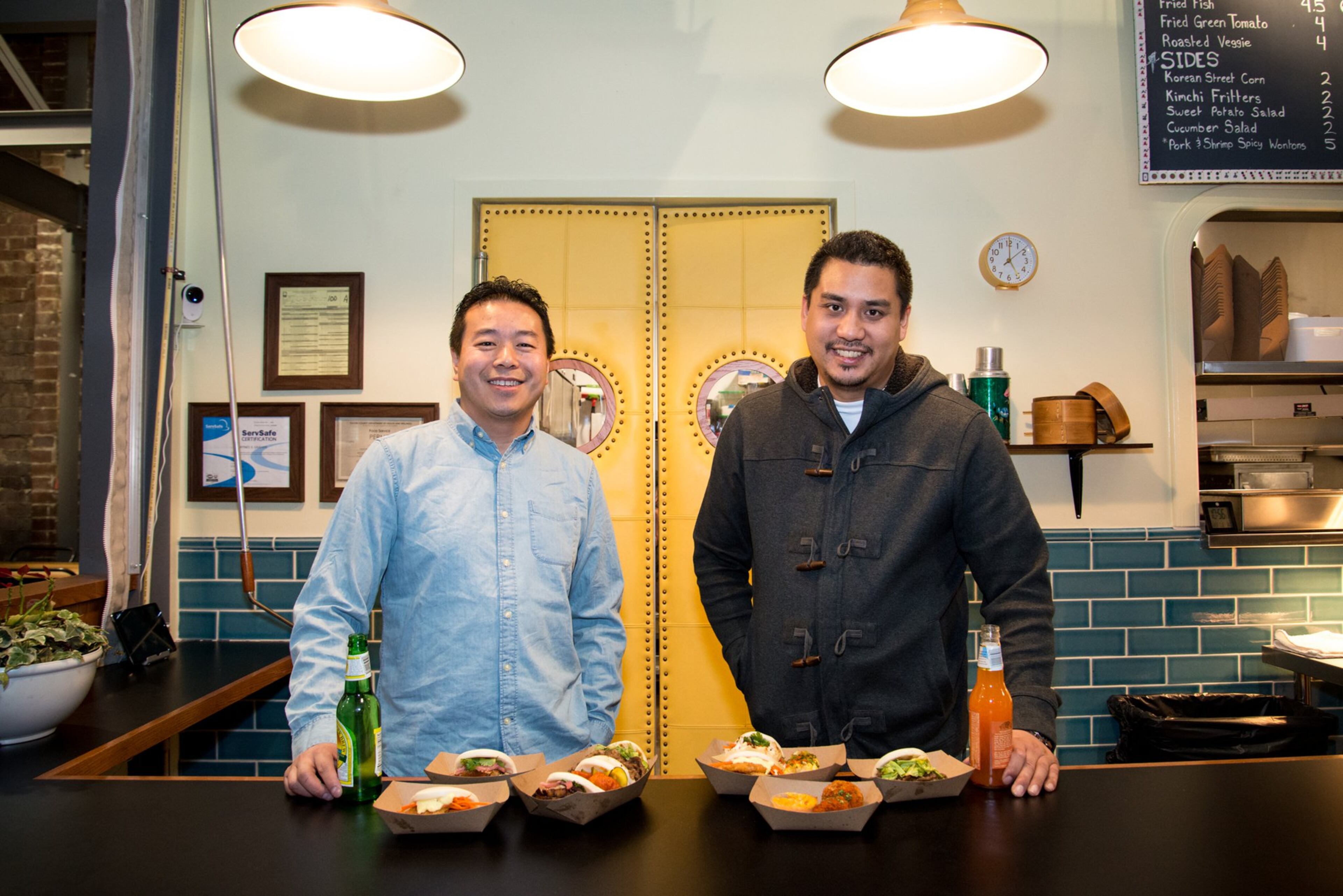 artners Michael Lo and George Yu behind the counter at Suzy Siu's Baos at Krog Street Market. Photo credit- Mia Yakel.