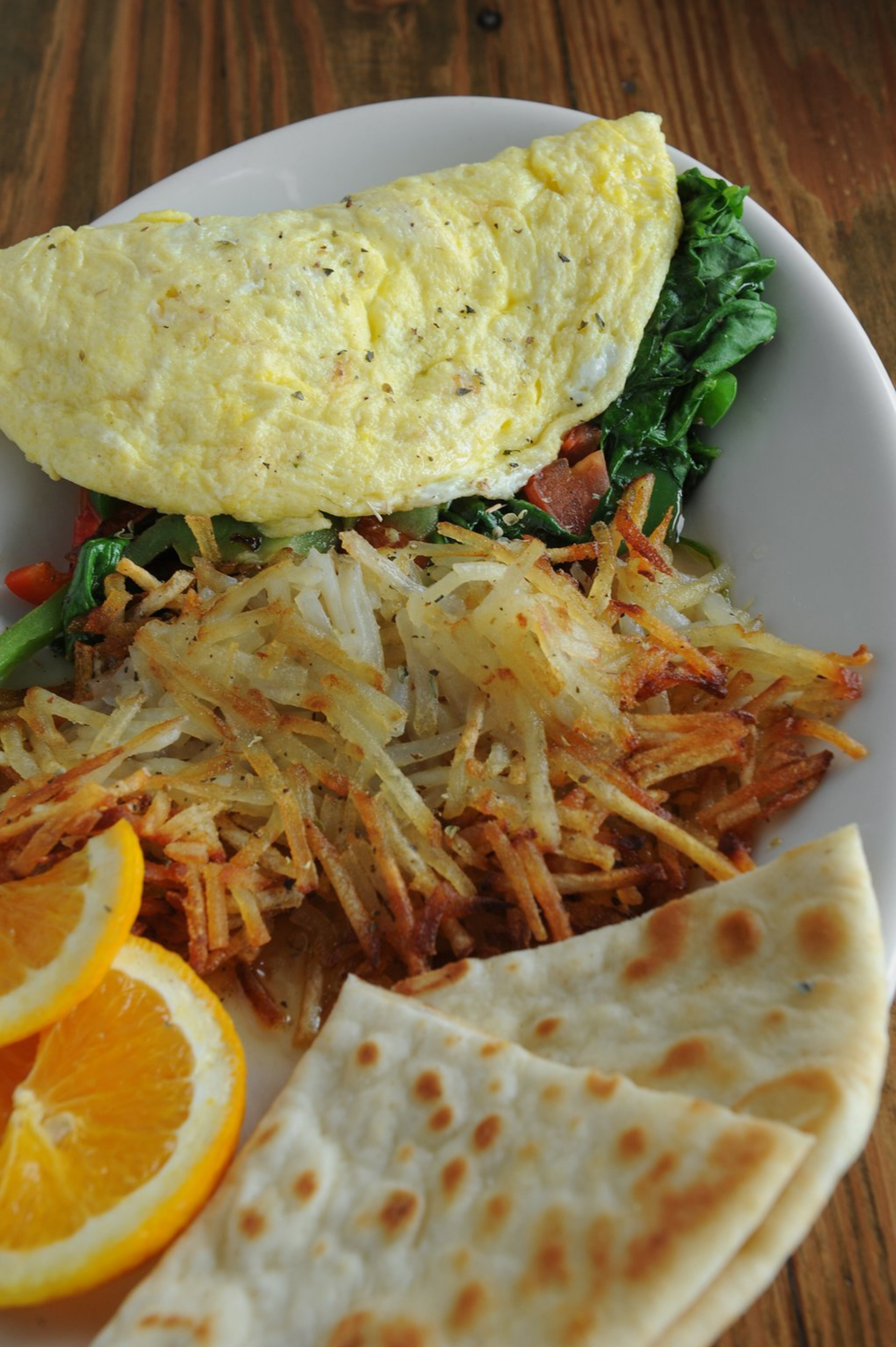 The Atalanta, spinach, tomato, green onion and bell pepper omelet, served with hash browns and pita bread. (Becky Stein Photography)