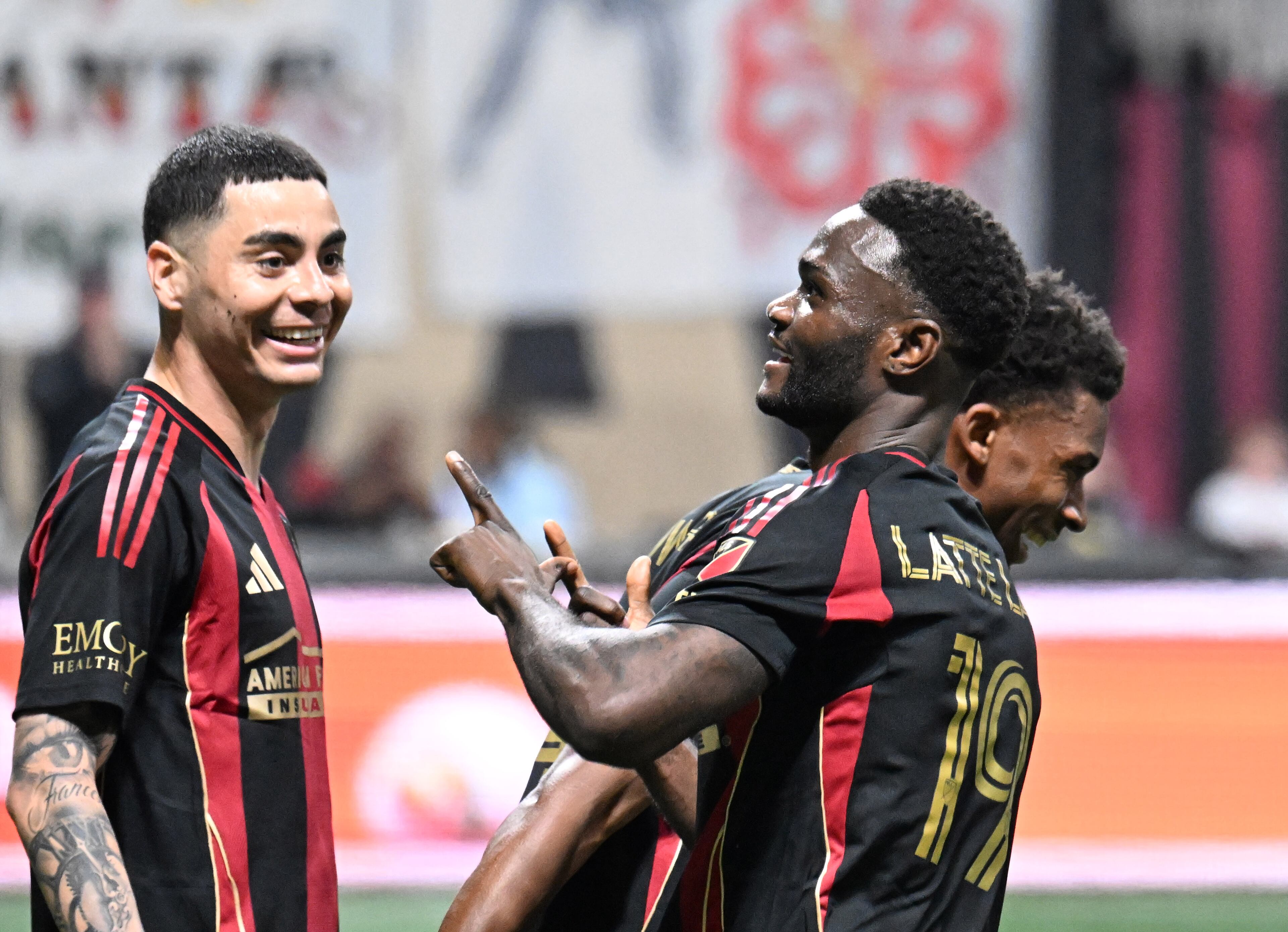Atlanta United forward Emmanuel Latte Lath (right) celebrates as Atlanta United midfielder Miguel AlmirĂ³n (left) looks on after scoring during the first half of Atlanta United’s MLS season opener at Mercedes-Benz Stadium, Saturday, February 22, 2025, in Atlanta. (Hyosub Shin / AJC)