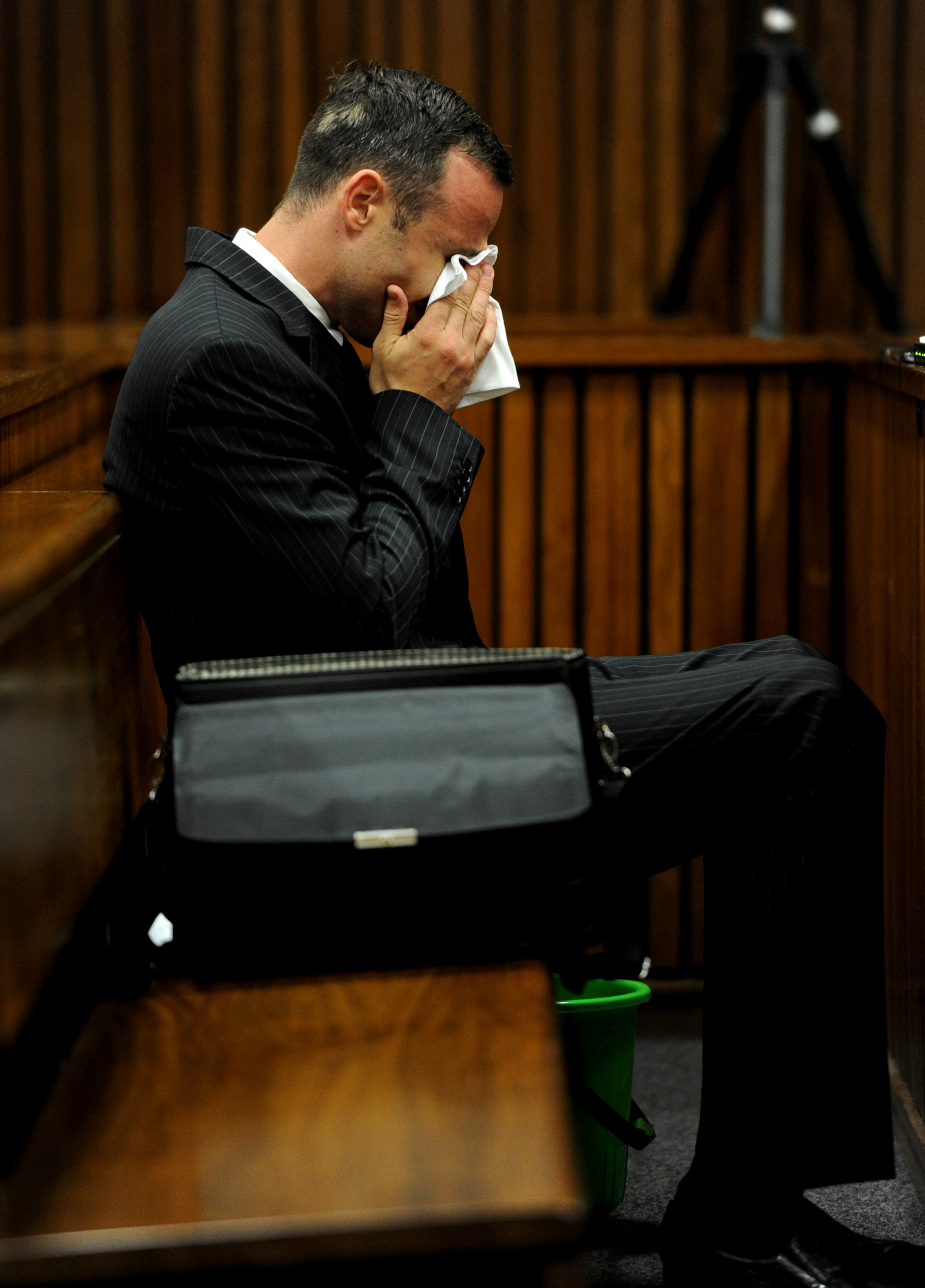 Oscar Pistorius, sits in the dock as he waits for proceedings to begin in court in Pretoria, South Africa, Tuesday, March 18, 2014. Pistorius is on trial for the murder of his girlfriend Reeva Steenkamp on Valentines Day, 2013. (AP Photo/Werner Beukes, Pool)