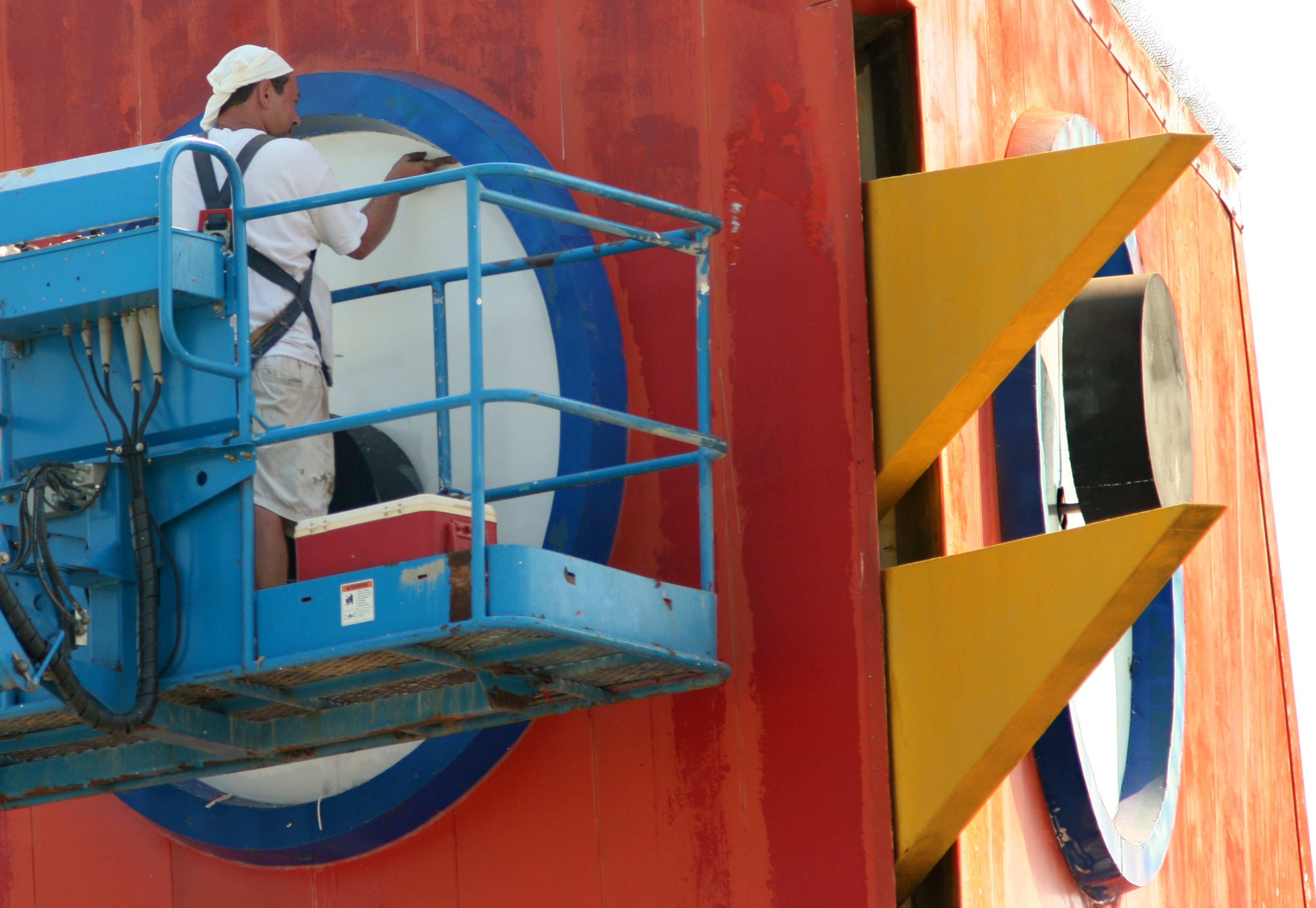 Painter Leonid Chubarov, of Kentucky-based Peabody Painting and Pressure Washing, helps put some finishing paint touches on the Big Chicken on June 25, 2008. The chicken is located at the corner of Cobb Parkway and Roswell Road in Marietta. When done painting, the chicken's iris will again be black and its beak bright yellow. The 3-week project will help reverse the effects the sun and other elements have had on the famous landmark.
