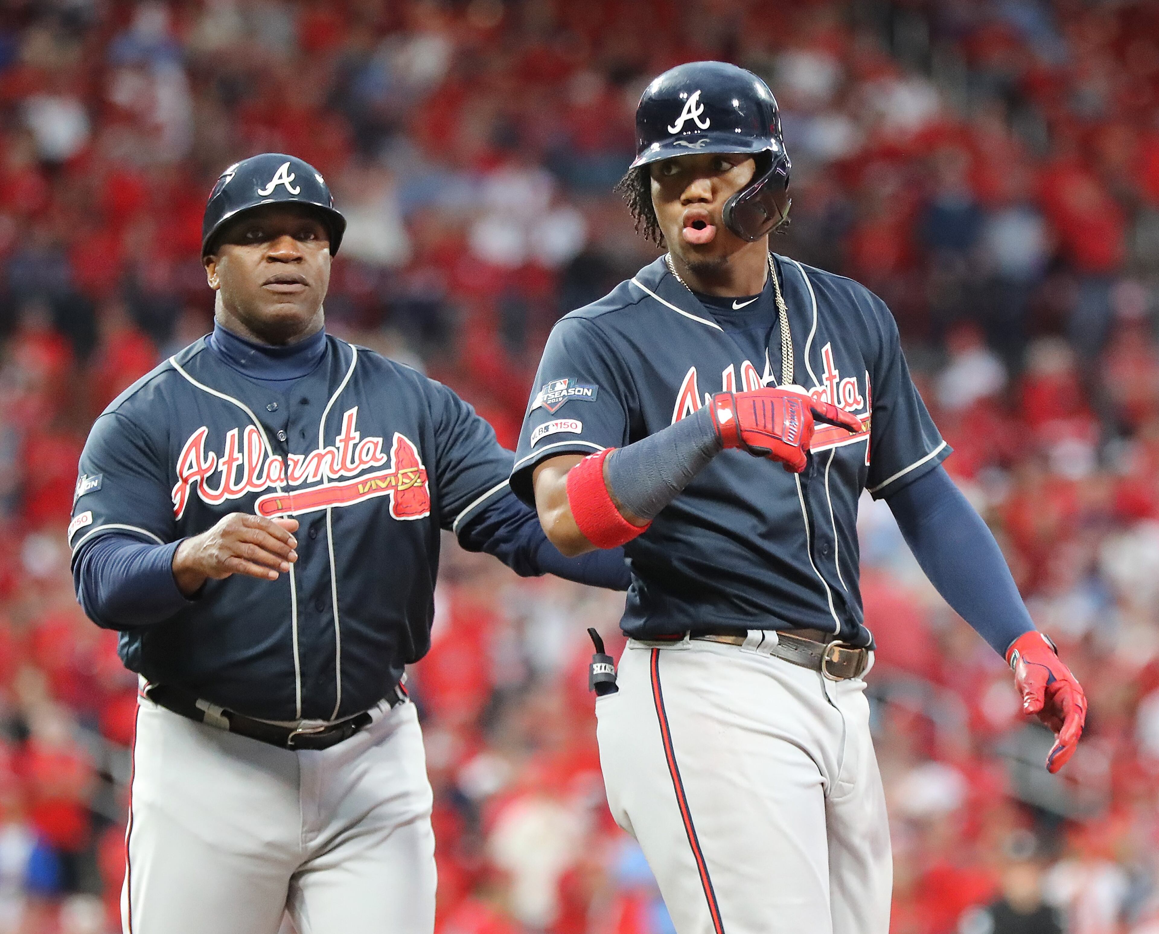 October 6, 2019 St. Louis: Atlanta Braves Ronald Acuna Jr. gets heated with the St. Louis Cardinals dugout walking to first base while drawing a walk during the 9th inning in game 3 of the NLDS on Sunday, October, 6, 2019, in St. Louis. The Braves first base coach Eric Young intervenes. Curtis Compton/ccompton@ajc.com