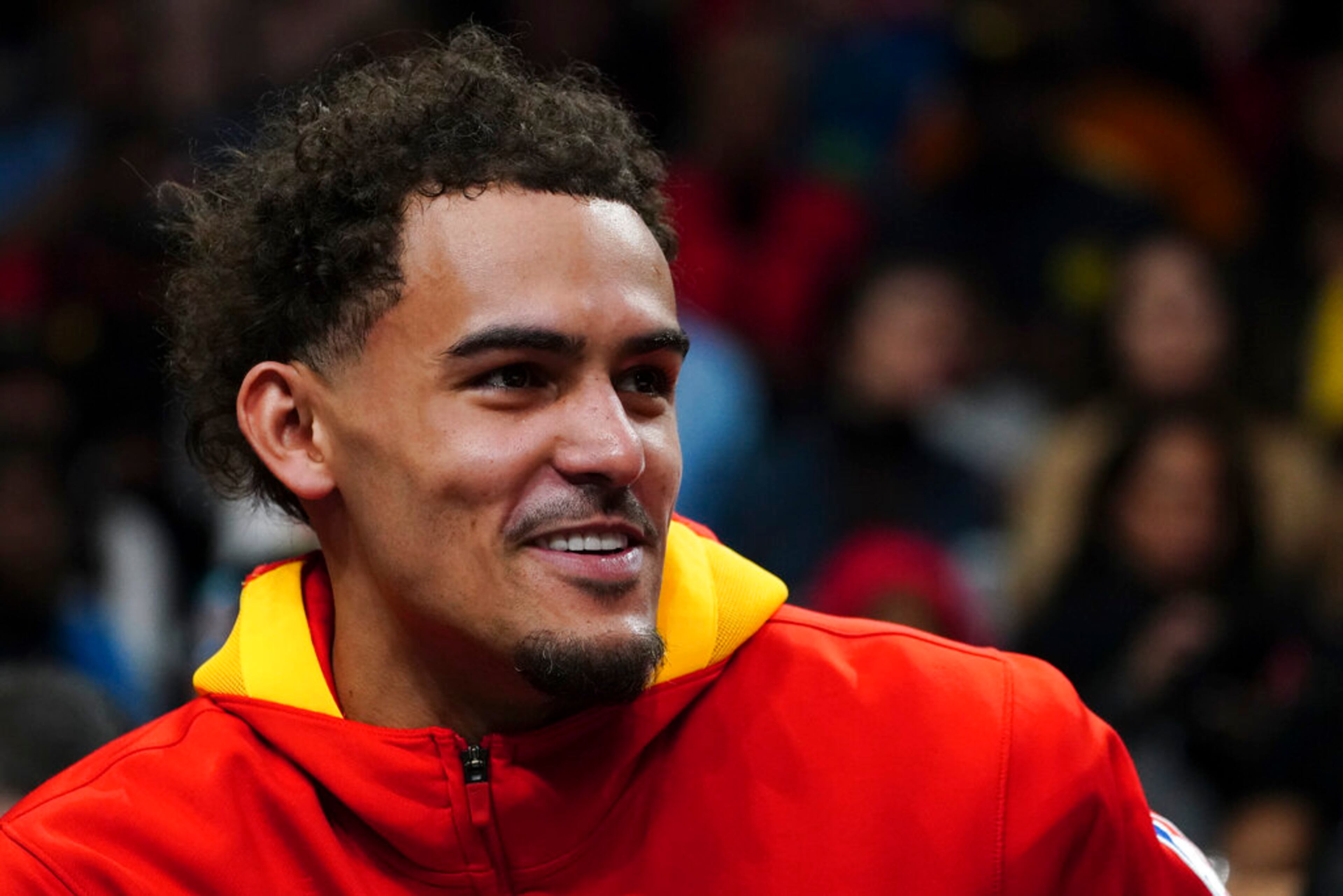 Atlanta Hawks guard Trae Young (11) smiles as he sits on the bench during a timeout during the first half of an NBA basketball game against the Portland Trail Blazers Friday, March 3, 2023, in Atlanta. (AP Photo/John Bazemore)