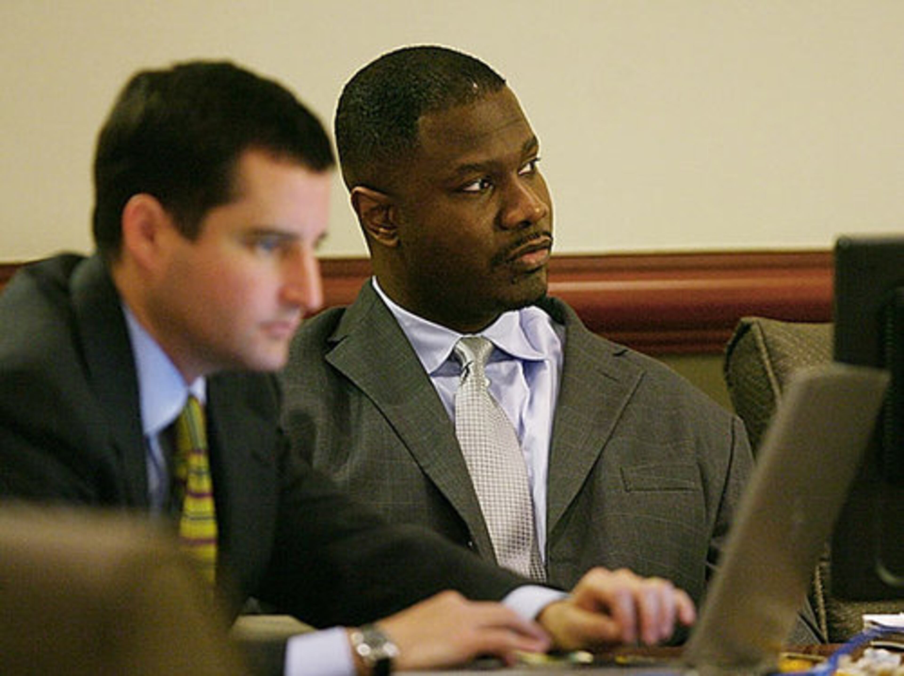 Defense attorney Josh Moore works at his computer as Brian Nichols listens to testimony Thursday.