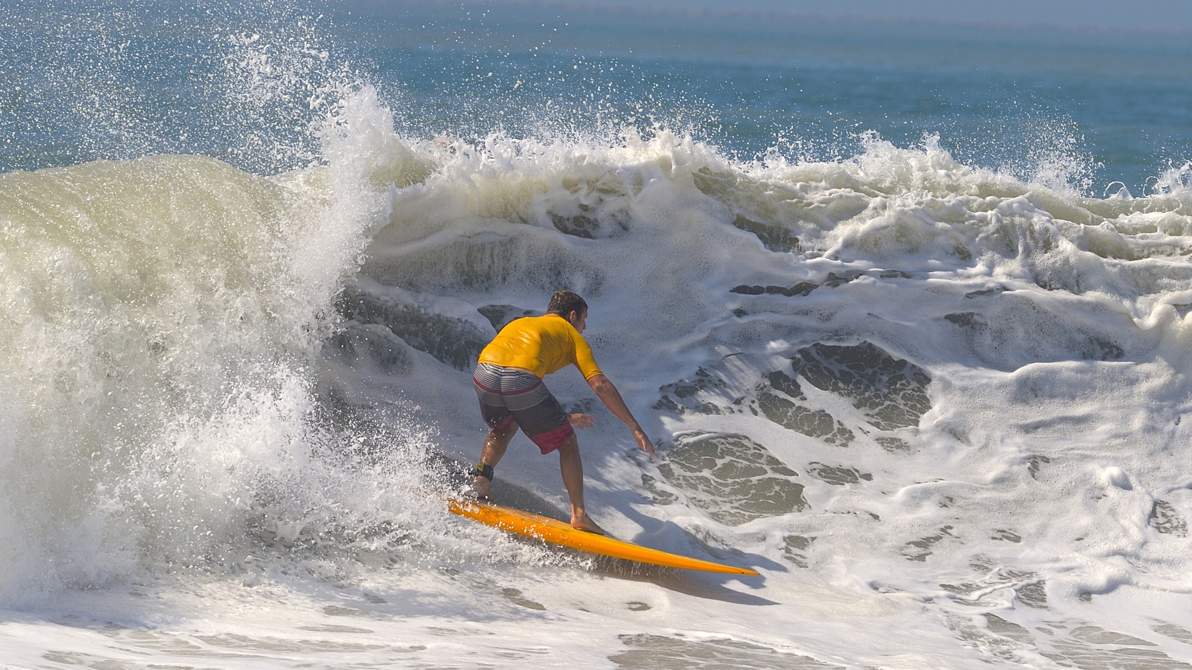 A surfer catches a wave in Belmont shore in Long Beach, Calif., in 2014. (Jeff Gritchen/Orange County Register/TNS)
