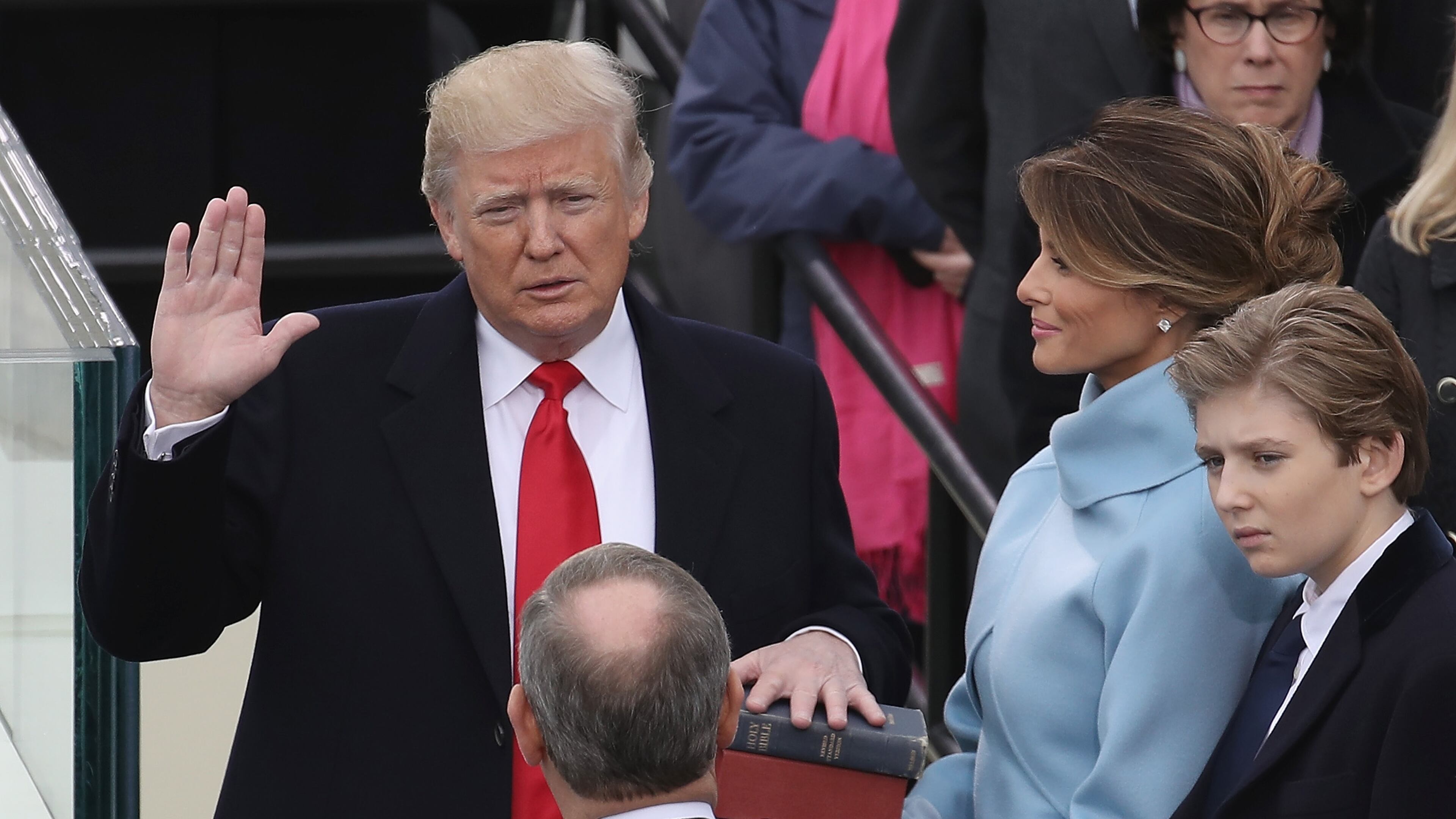 WASHINGTON, DC - JANUARY 20: Supreme Court Justice John Roberts (2L) administers the oath of office to U.S. President Donald Trump (L) as his wife Melania Trump holds the Bible and son Barron Trump looks on, on the West Front of the U.S. Capitol on January 20, 2017 in Washington, DC. In today's inauguration ceremony Donald J. Trump becomes the 45th president of the United States. (Photo by Drew Angerer/Getty Images)