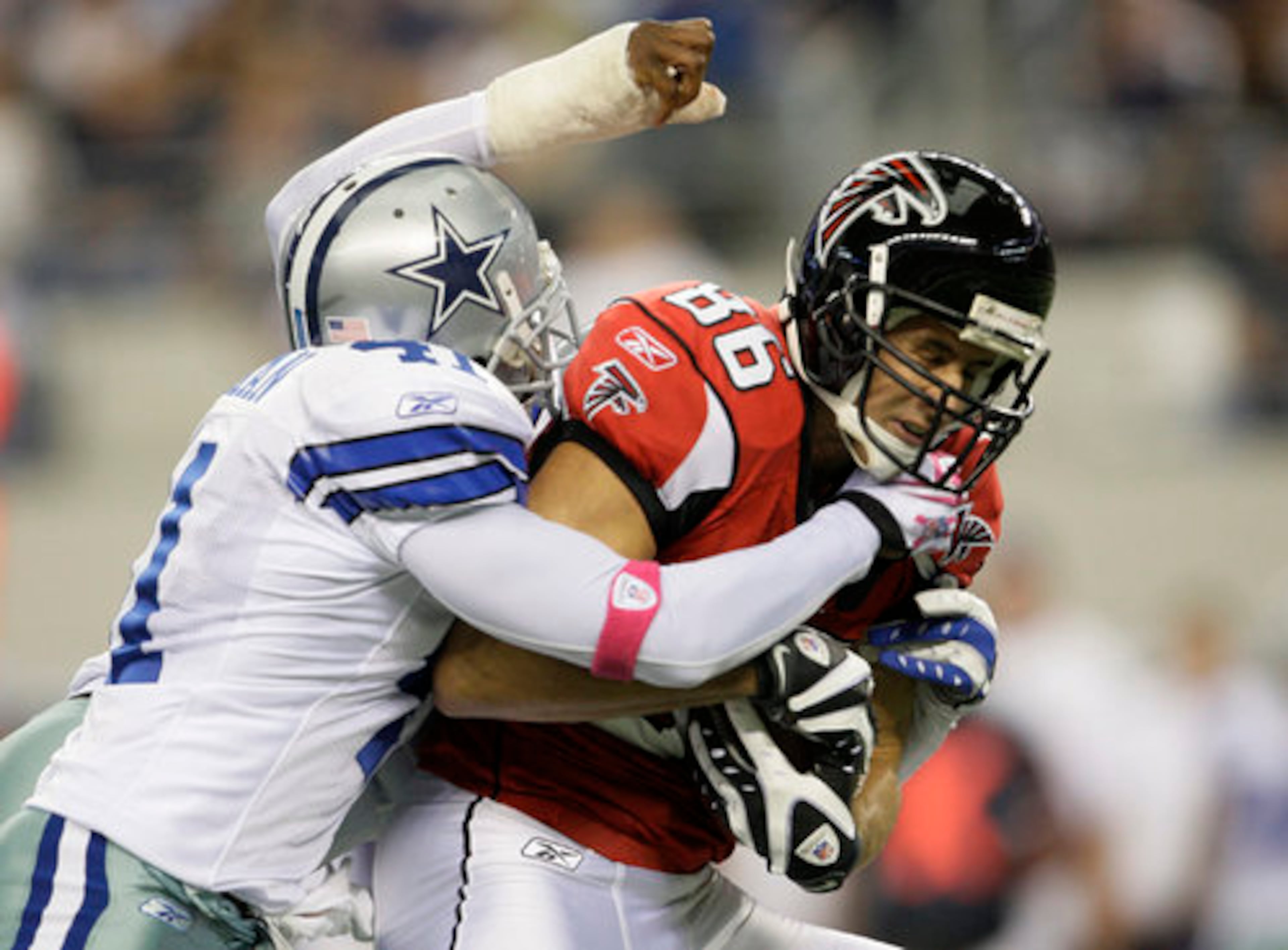 Cowboys cornerback Terence Newman (41) attempts to bring down Falcons wide receiver Brian Finneran.