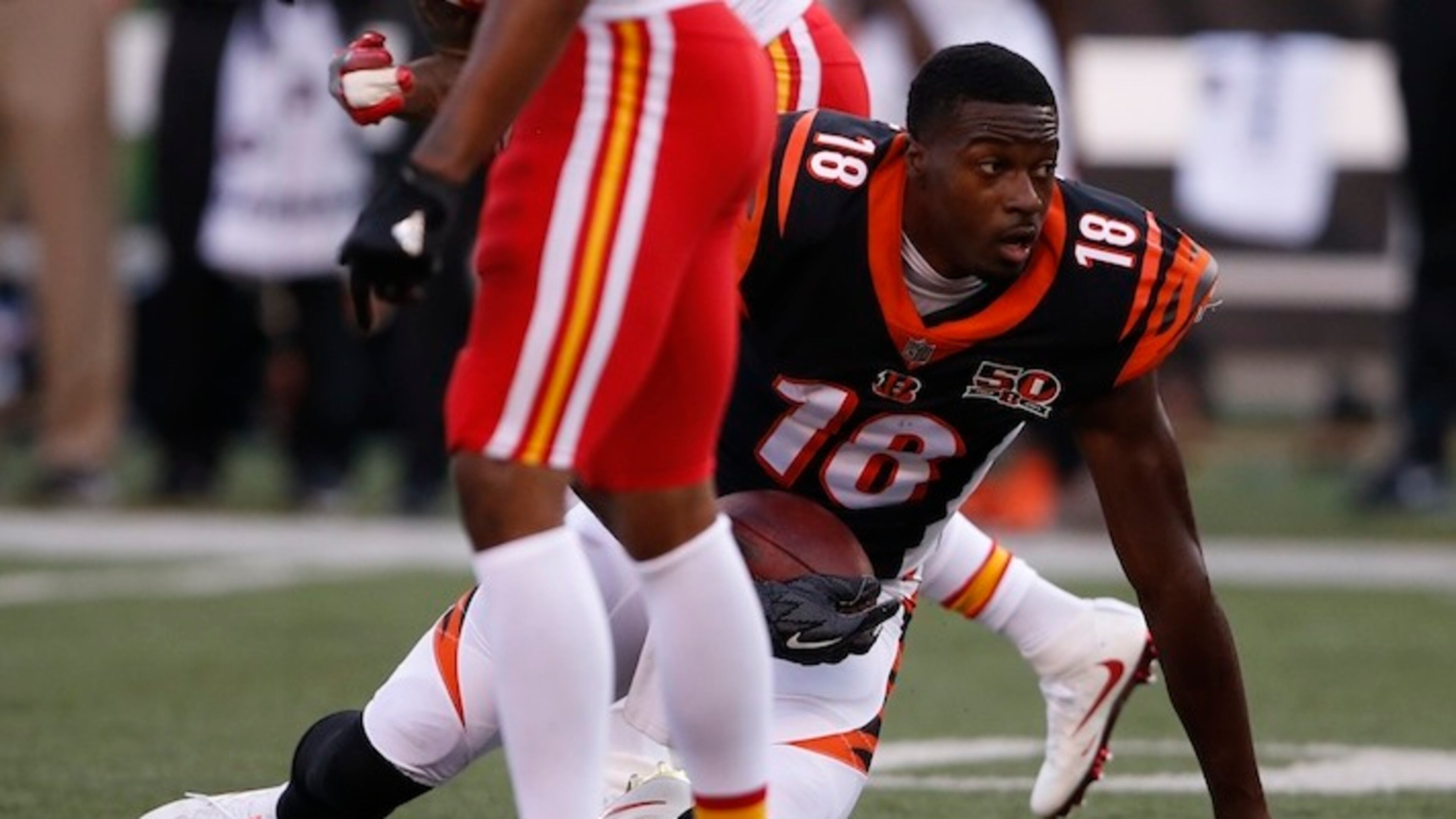 Cincinnati Bengals wide receiver A.J. Green (18) loses his helmet after making a reception in the first half of an NFL preseason football game against the Kansas City Chiefs, Saturday, Aug. 19, 2017, in Cincinnati. (AP Photo/Gary Landers)