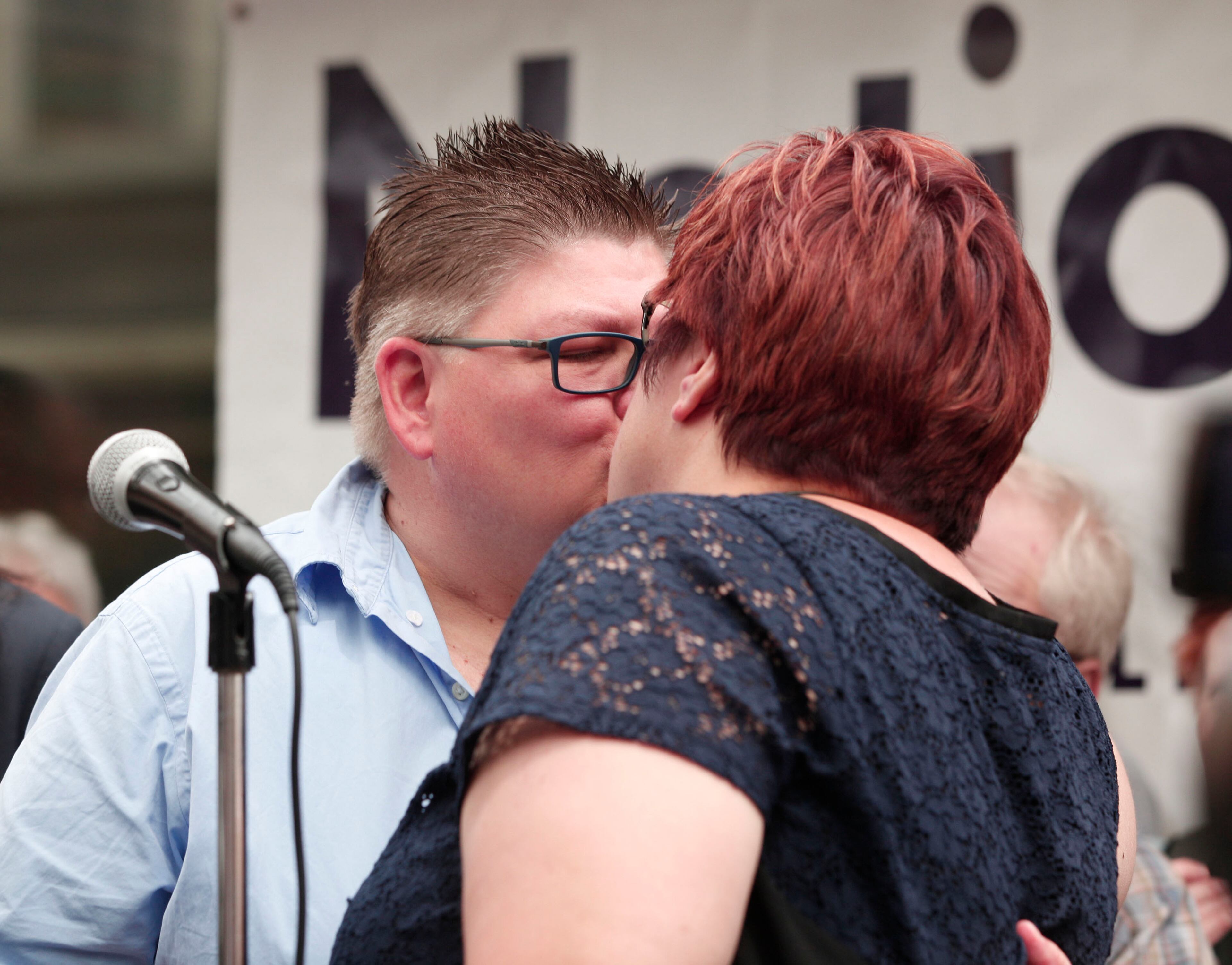 ANN ARBOR, MI - JUNE 26: April DeBoer (right) and Jayne Rowse (left), a same-sex couple with four adopted children, kiss at a press confrence held to discuss the Supreme Court's ruling on gay marriage, June 26th, 2015 in Ann Arbor, Michigan. The U.S. Supreme Court ruled that same-sex couples have the right t marry in all 50 states. (Photo by Bill Pugliano/Getty Images)