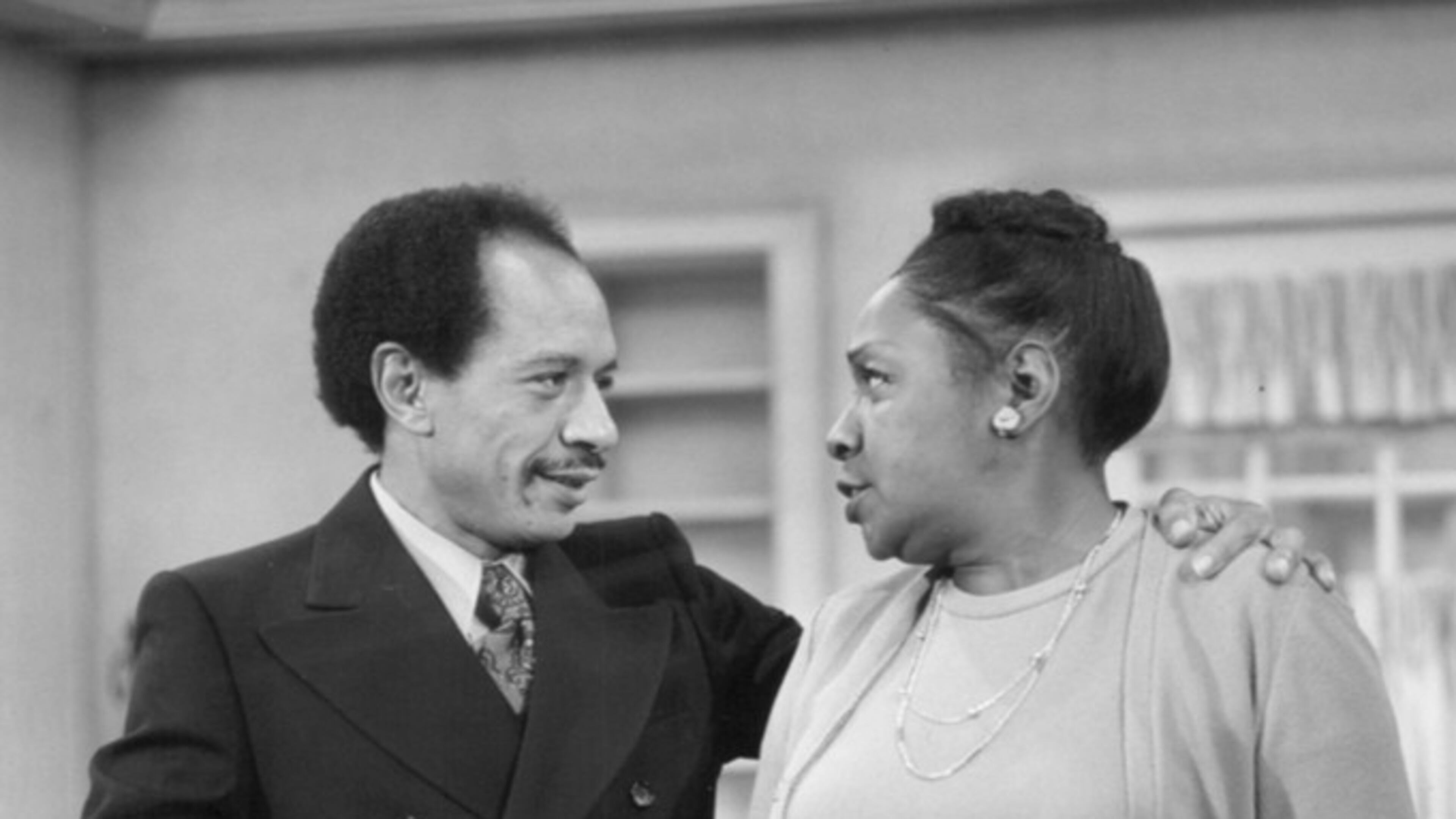 Publicity photo from "All in the Family." Pictured are Sherman Helmsley (George Jefferson) and Isabel Sanford (Louise Jefferson) as they pack to move from Queens to Manhattan. This began the television series "The Jeffersons." The press release is dated Dec. 12, 1974 and the "All in the Family" episode aired 11 January 1975. (CBS Television Network / Wikimedia)